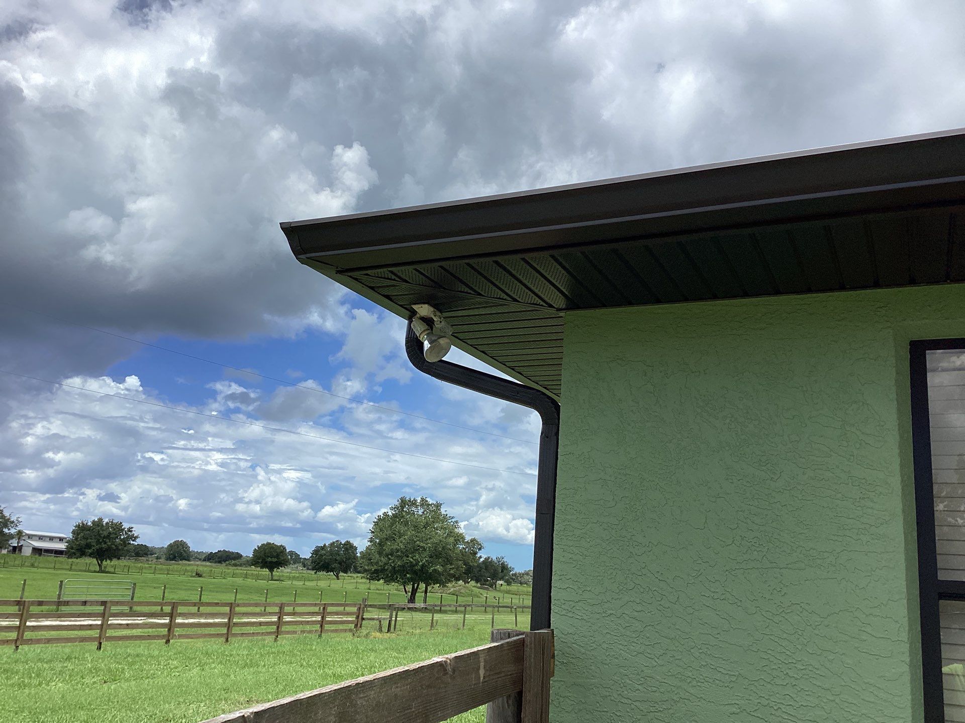 Musket brown downspouts with 6-inch K-Style gutter installation in Myakka City, FL by Gutter Professors