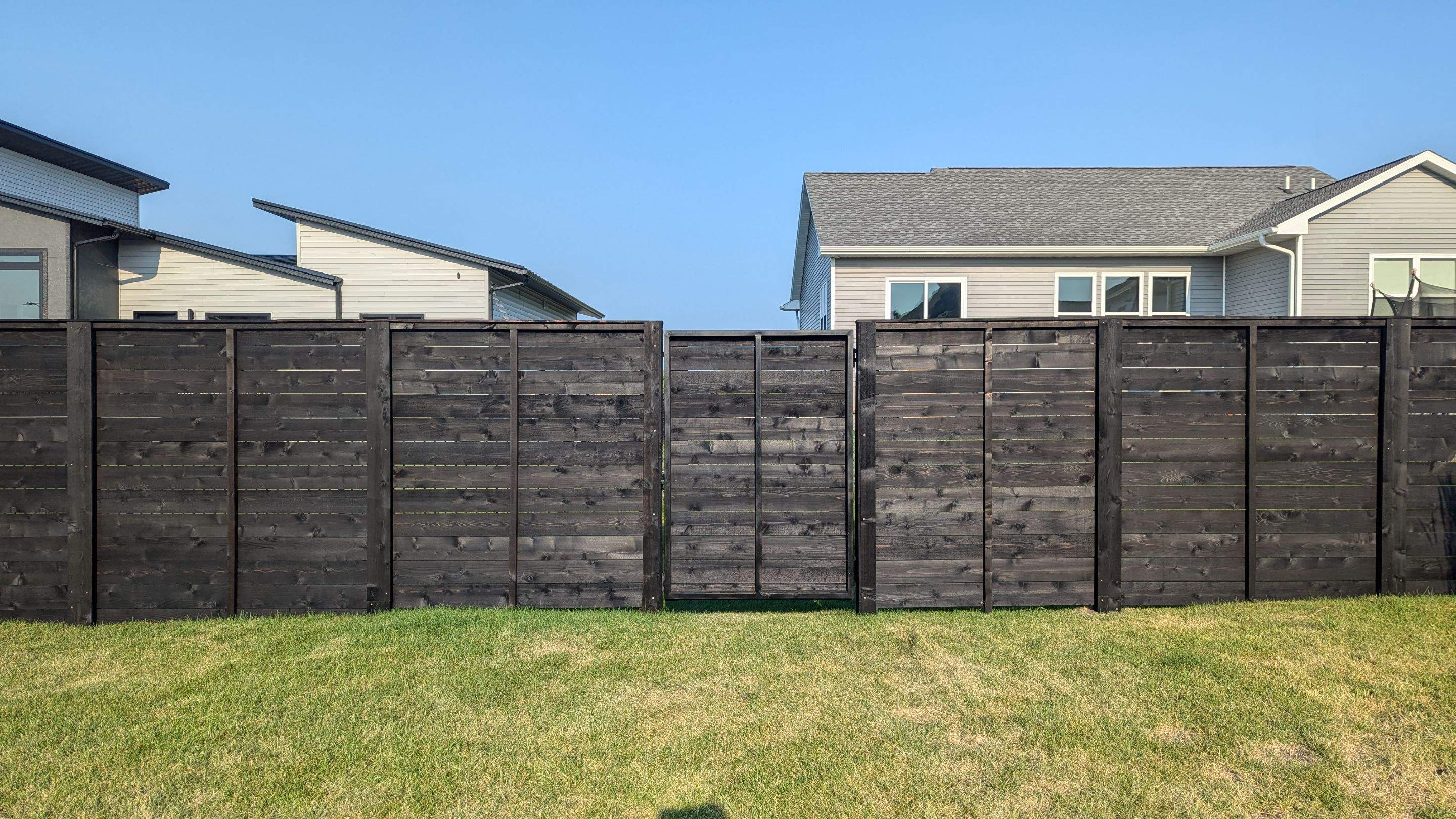 Modern Black Stained Horizontal Privacy Fence Installation in Cedar by Perfect Picket Fence and Stain