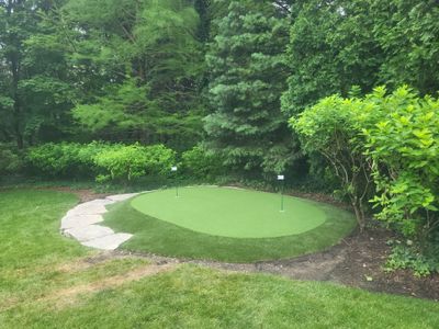 Small New Albany Synthetic Turf Putting Green with Natural Stone Border