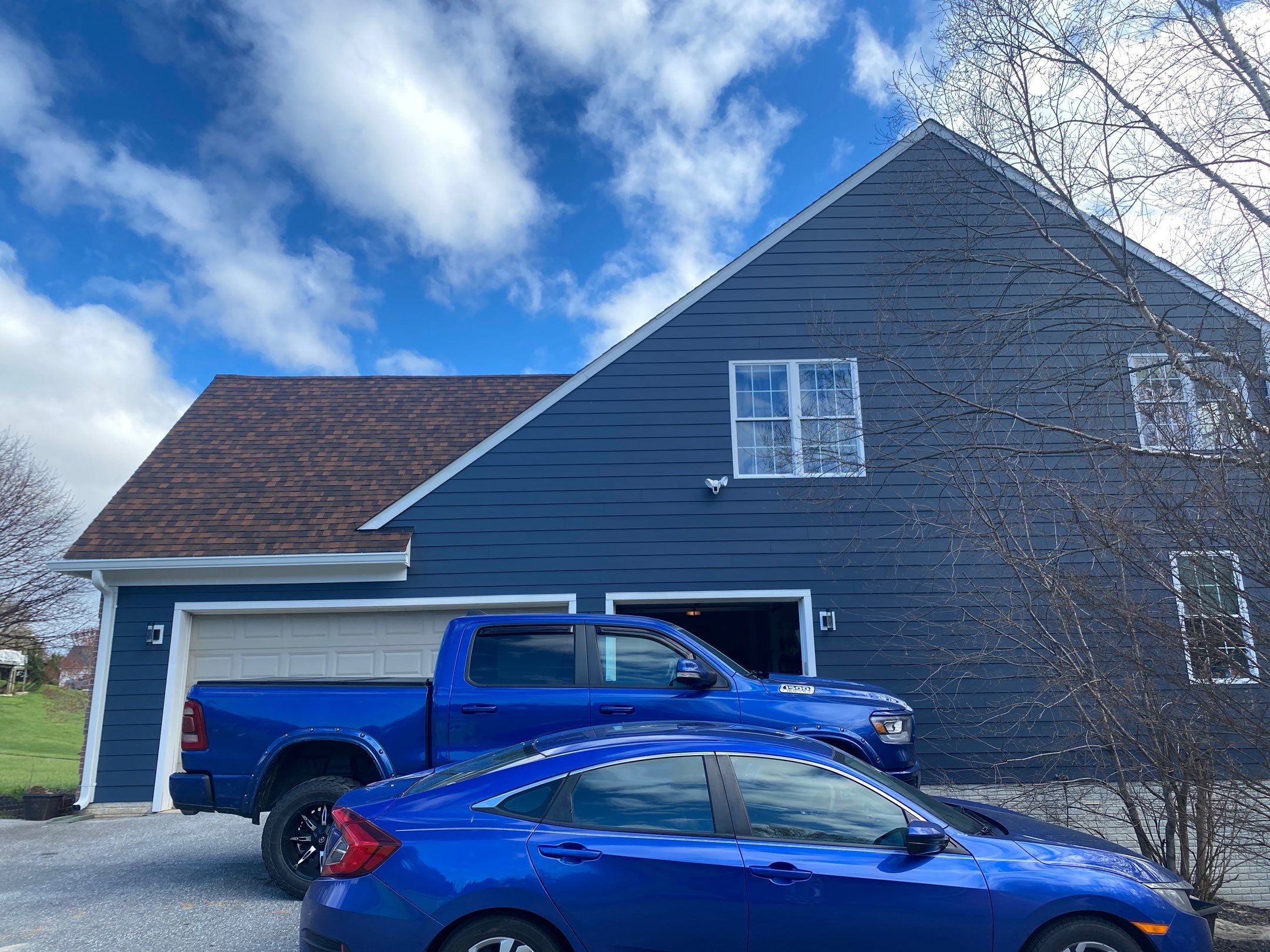 James Hardie Plank Siding + Seamless Gutters by American Home Contractors