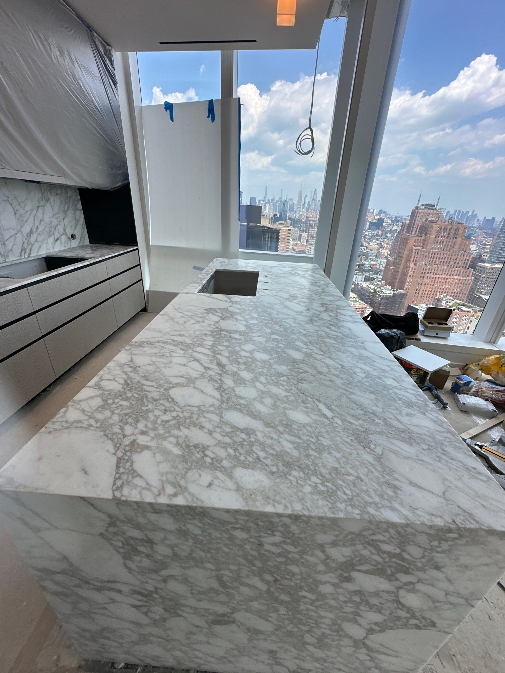 Kitchen Countertop with backsplash and Island top with mitered waterfalls by NC Stone And Tiles