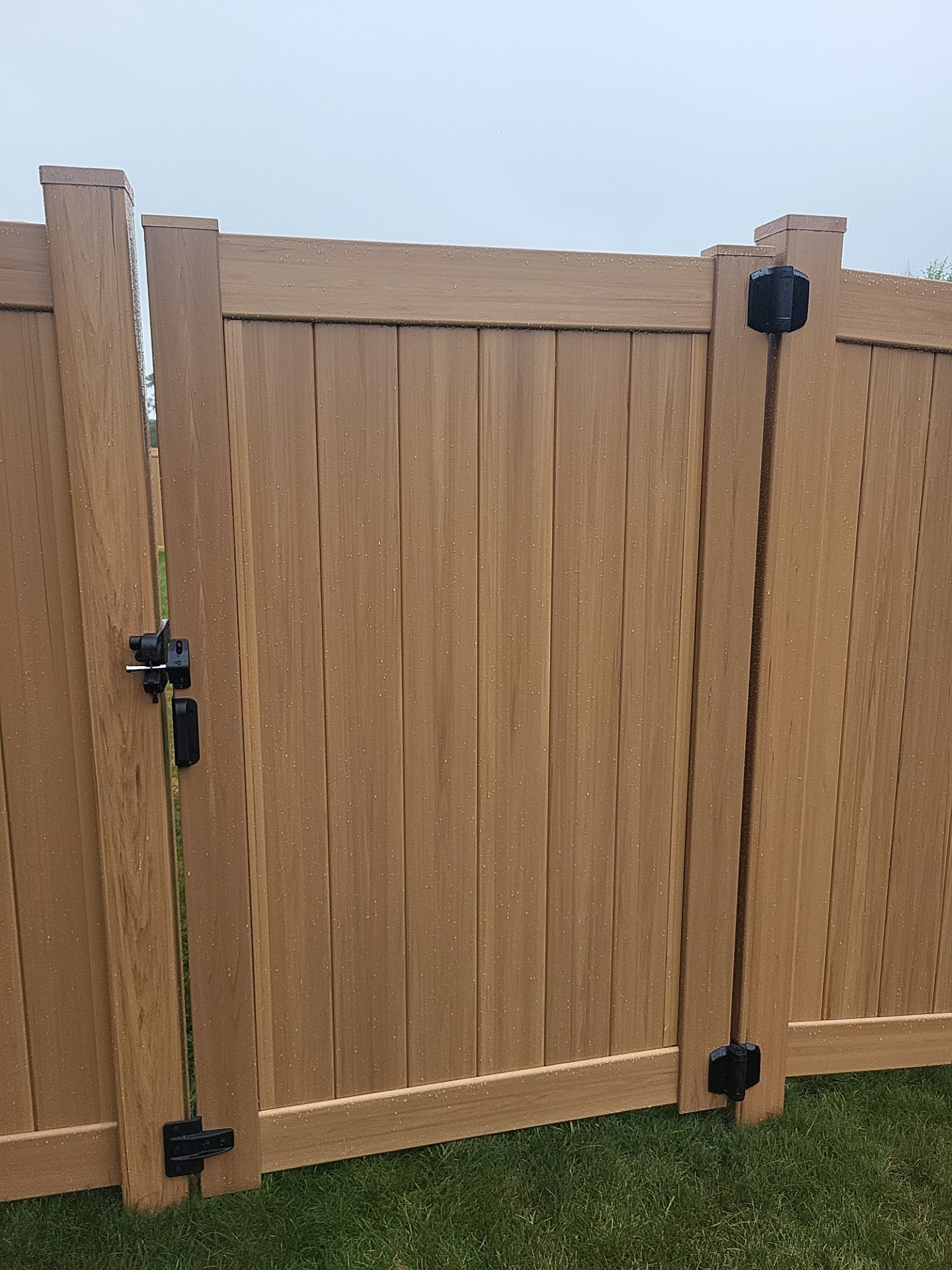 Residential Cypress Vinyl Privacy Fence Installation in Cedar Falls by Perfect Picket Fence and Stain