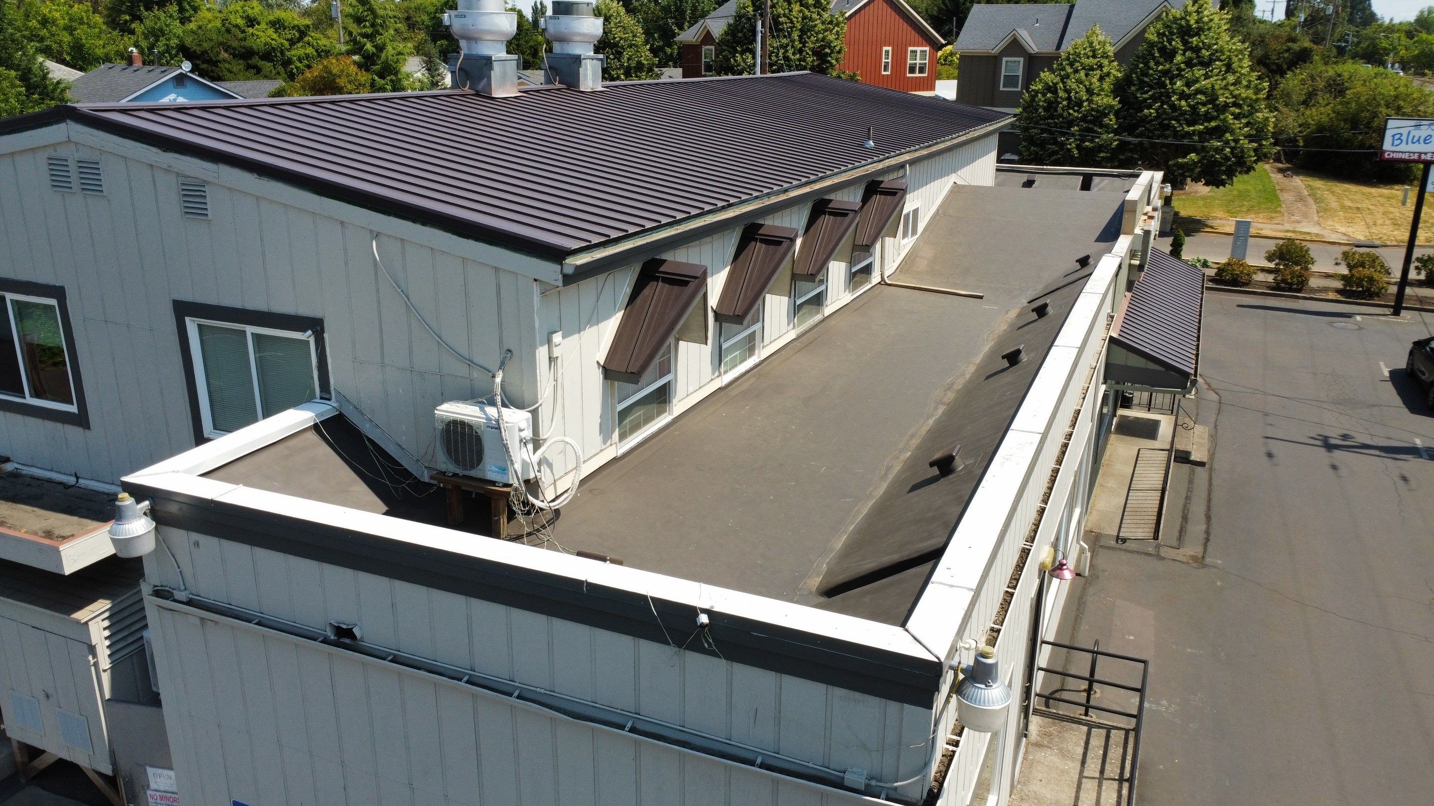 Commercial Flat Roof Installation using Bruce and Dana Snap Lock Metal (Color: Brown) by Orezona Building & Roofing Company, Inc.