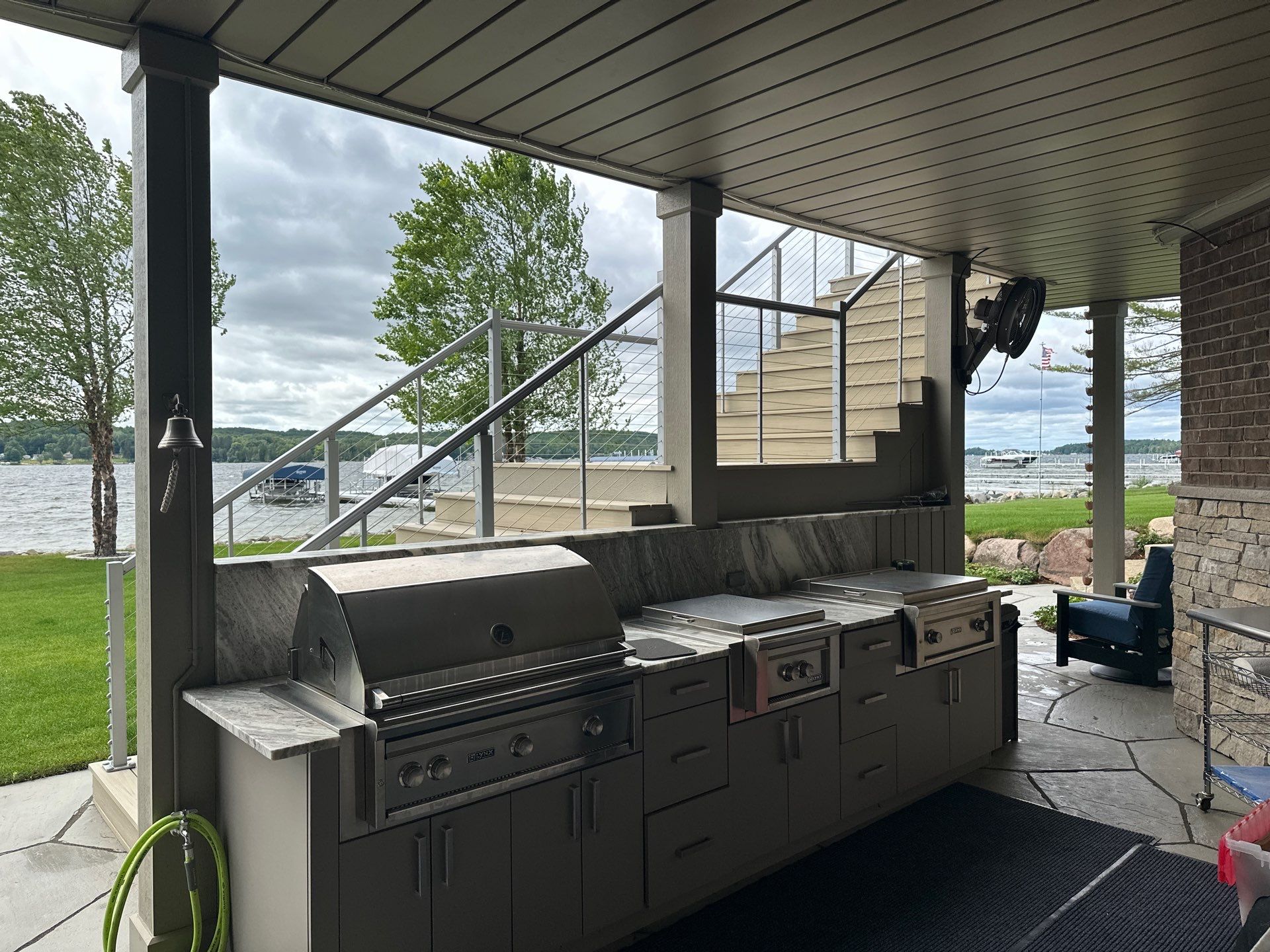 Custom Underdecking System and Outdoor Kitchen in East Jordan by Rainbow Seamless Systems