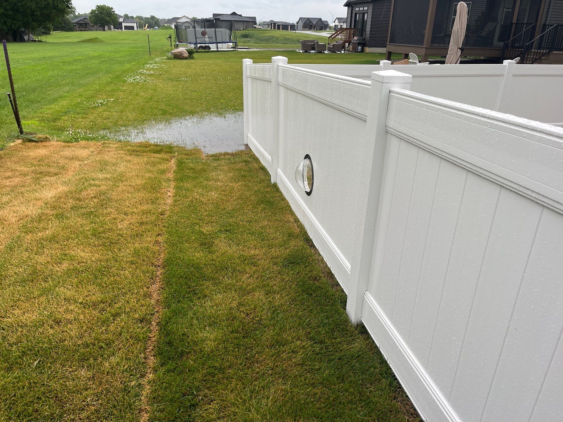 White Vinyl Privacy Fence With Pet Window in Cedar Falls by Perfect Picket Fence and Stain