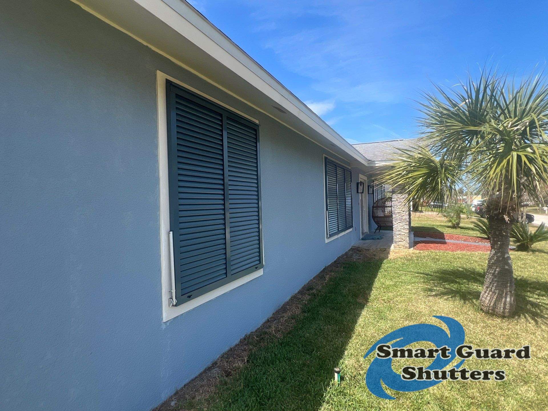 Impact Bahama Shutters in Grey Blue by Smart Guard Shutters