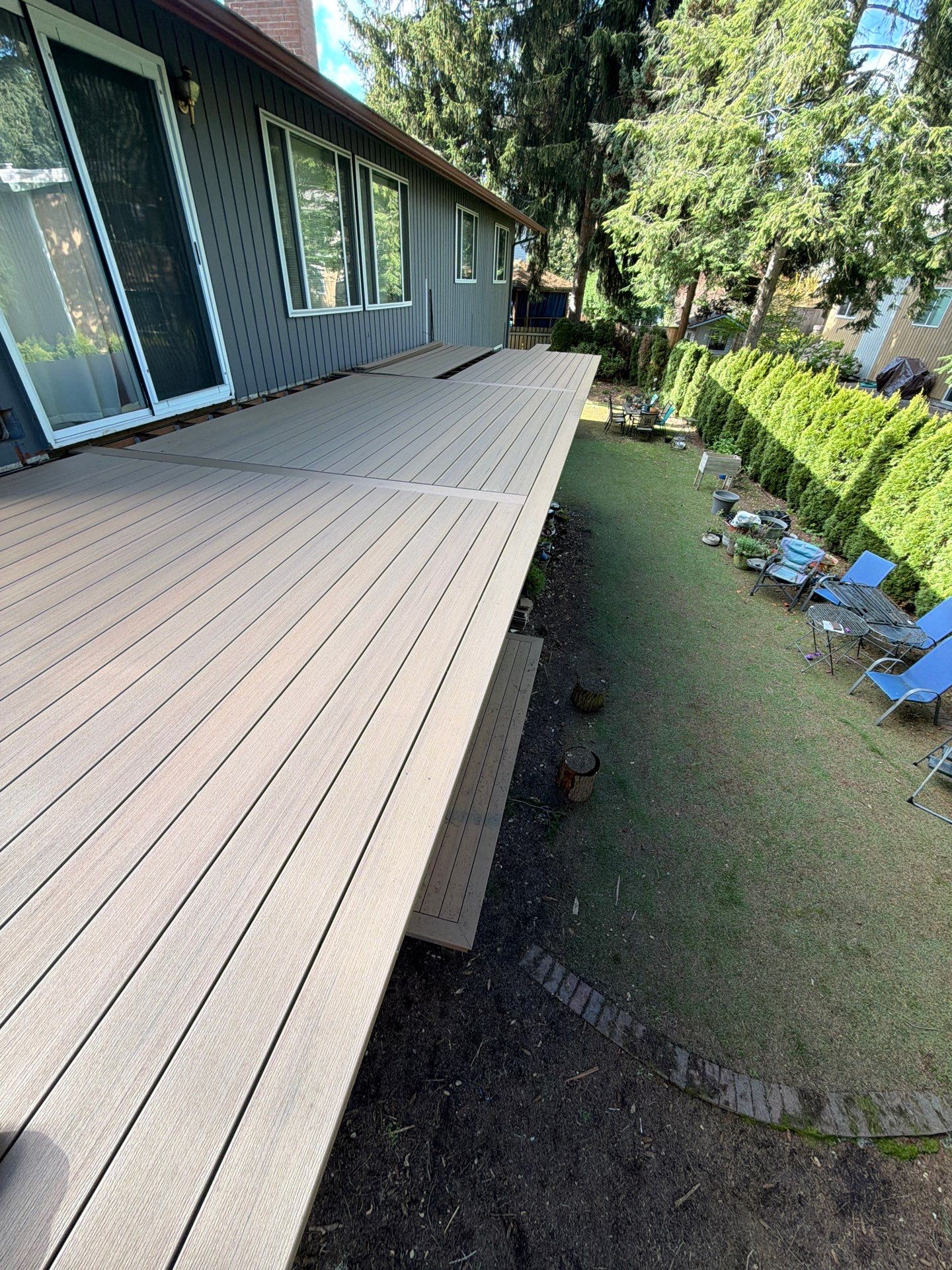 Elevated TimberTech Composite Deck Replacement With Black Metal Railings by Emerald City Energy