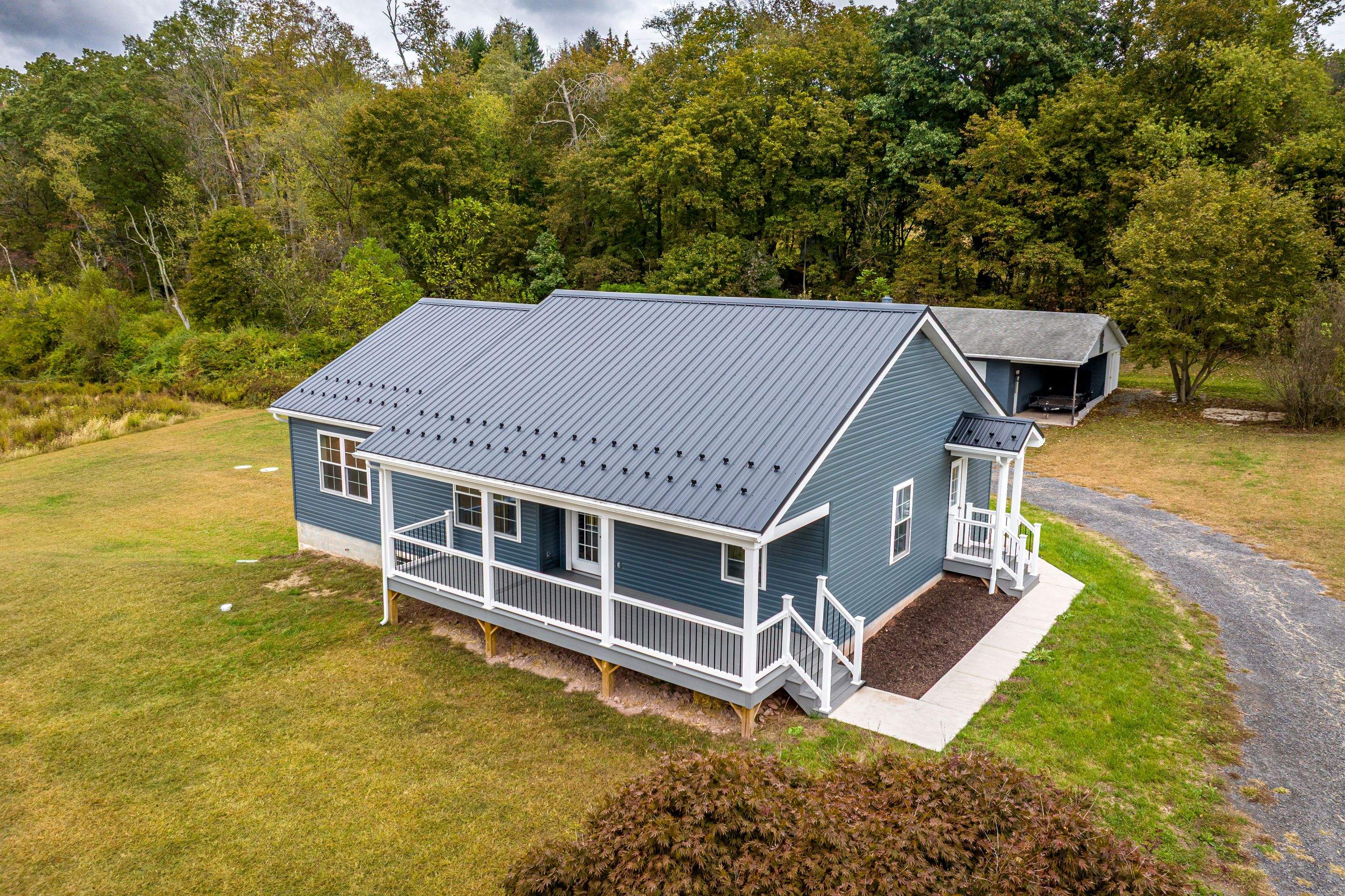 New Residential Addition with Blue Siding and Metal Roofing in Ashland by Esh Builders