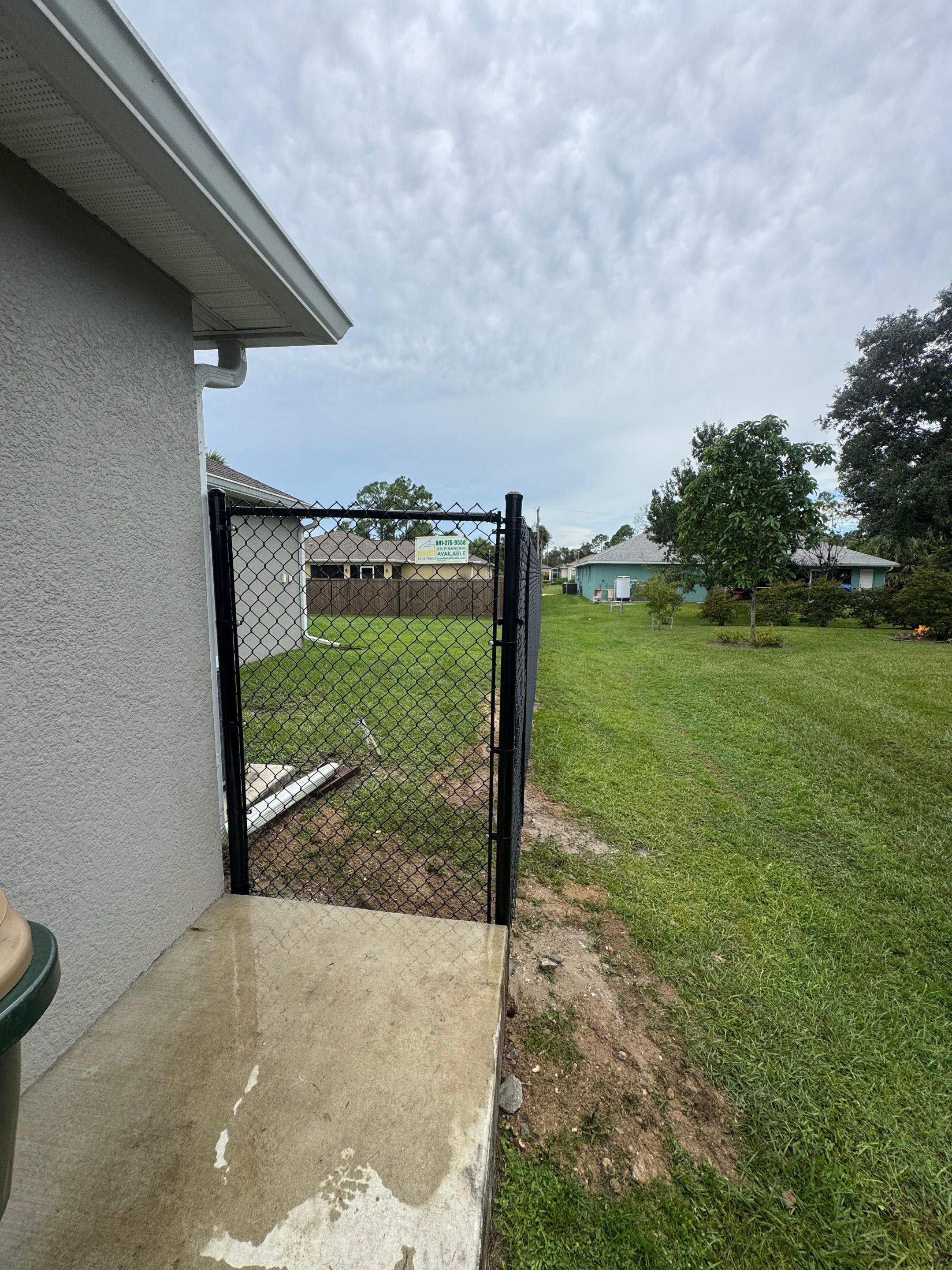 Black Chain Link Boundary Fence with Access Gates in North Port by True Fence LLC