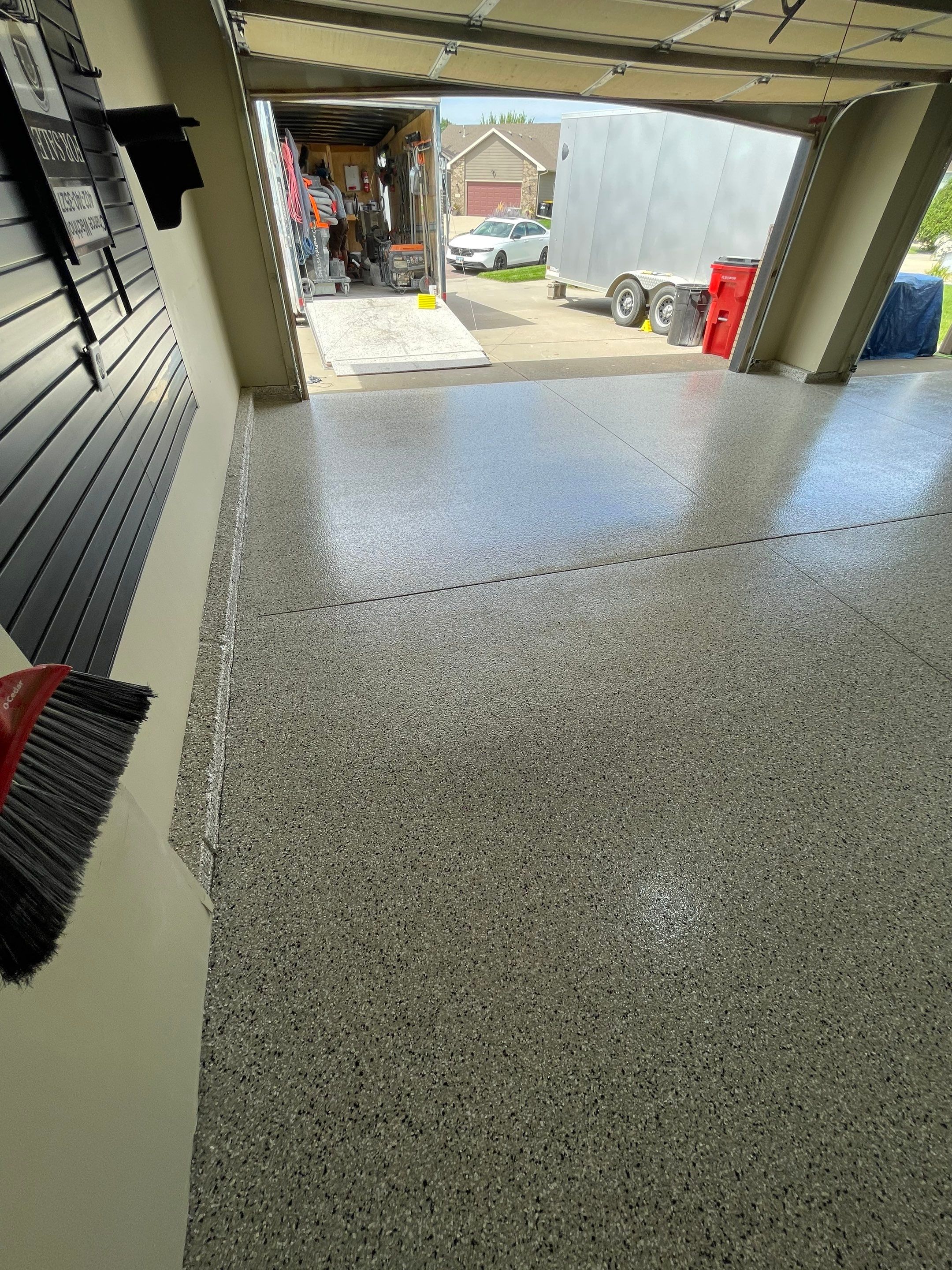 Cabin FEver Flake Garage Floor Coating Installation in Sioux Falls by Select Painting, Coatings & Garage Cabinets