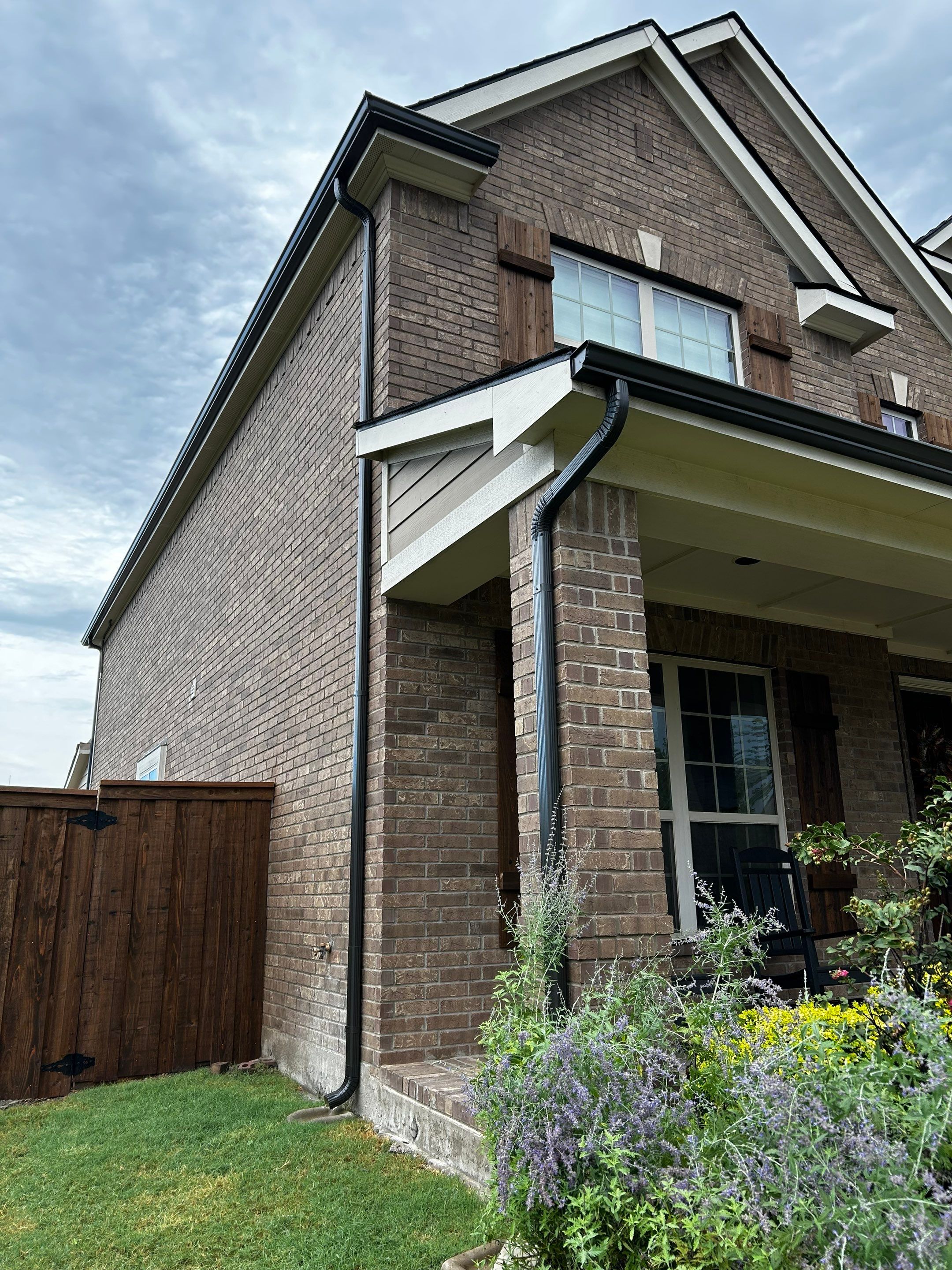 Medium brown brick with GAF Pewter Gray  by Tejas Roofworks + Restoration