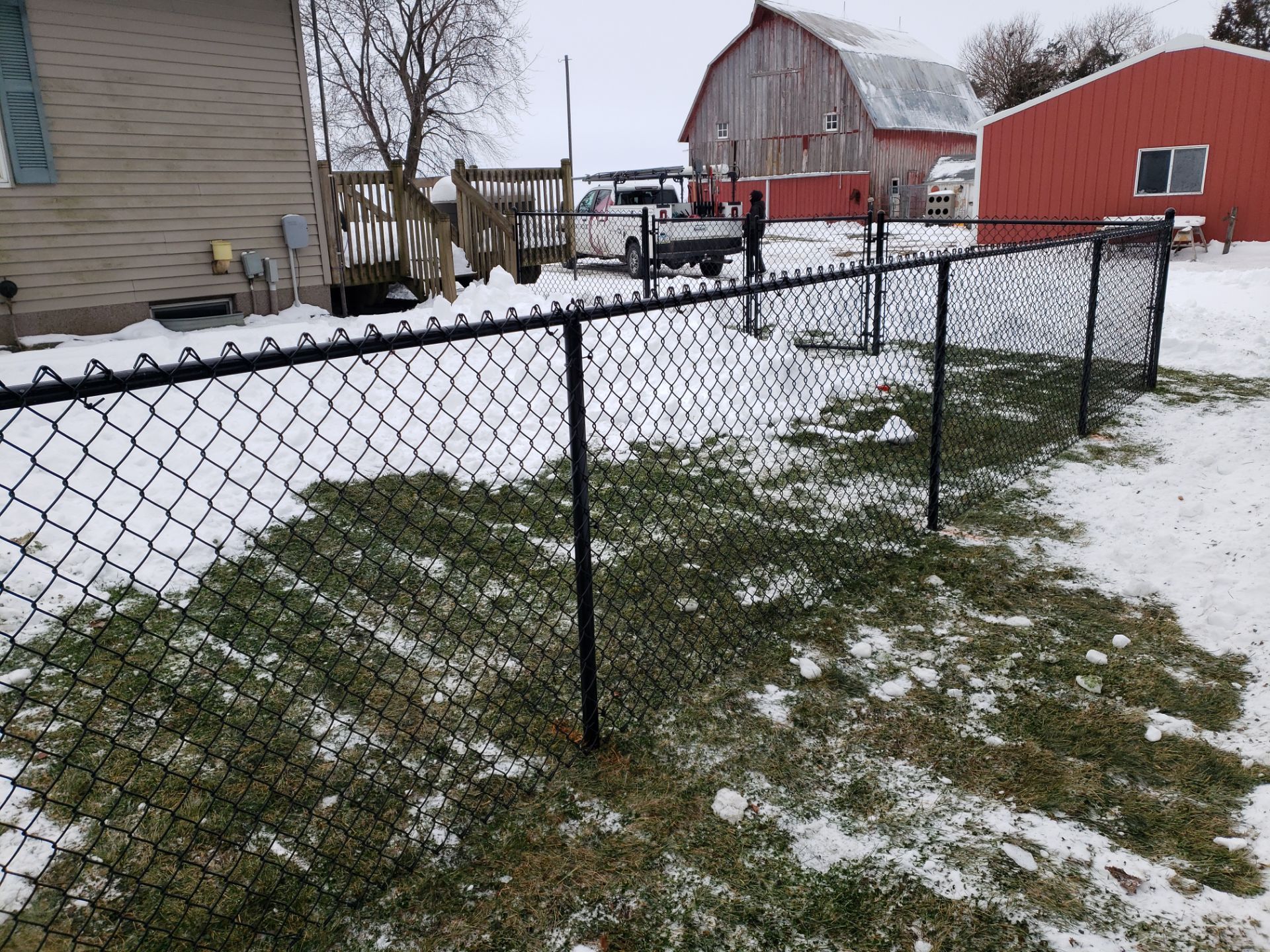 Black Vinyl-Coated Chain Link Fence Installation in Oelwein by Perfect Picket Fence and Stain