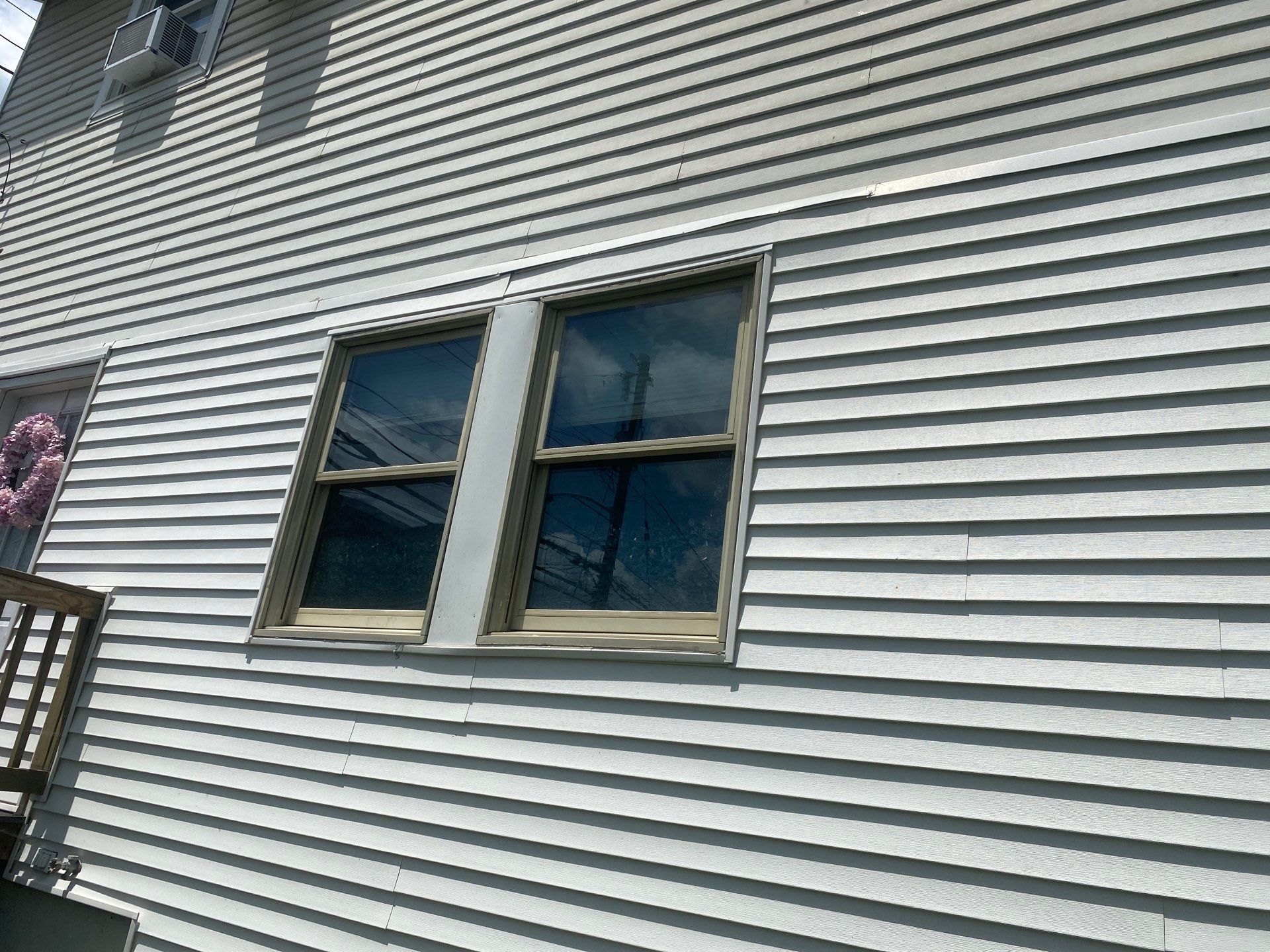 White siding  by Cousins Roofing Siding & Decks