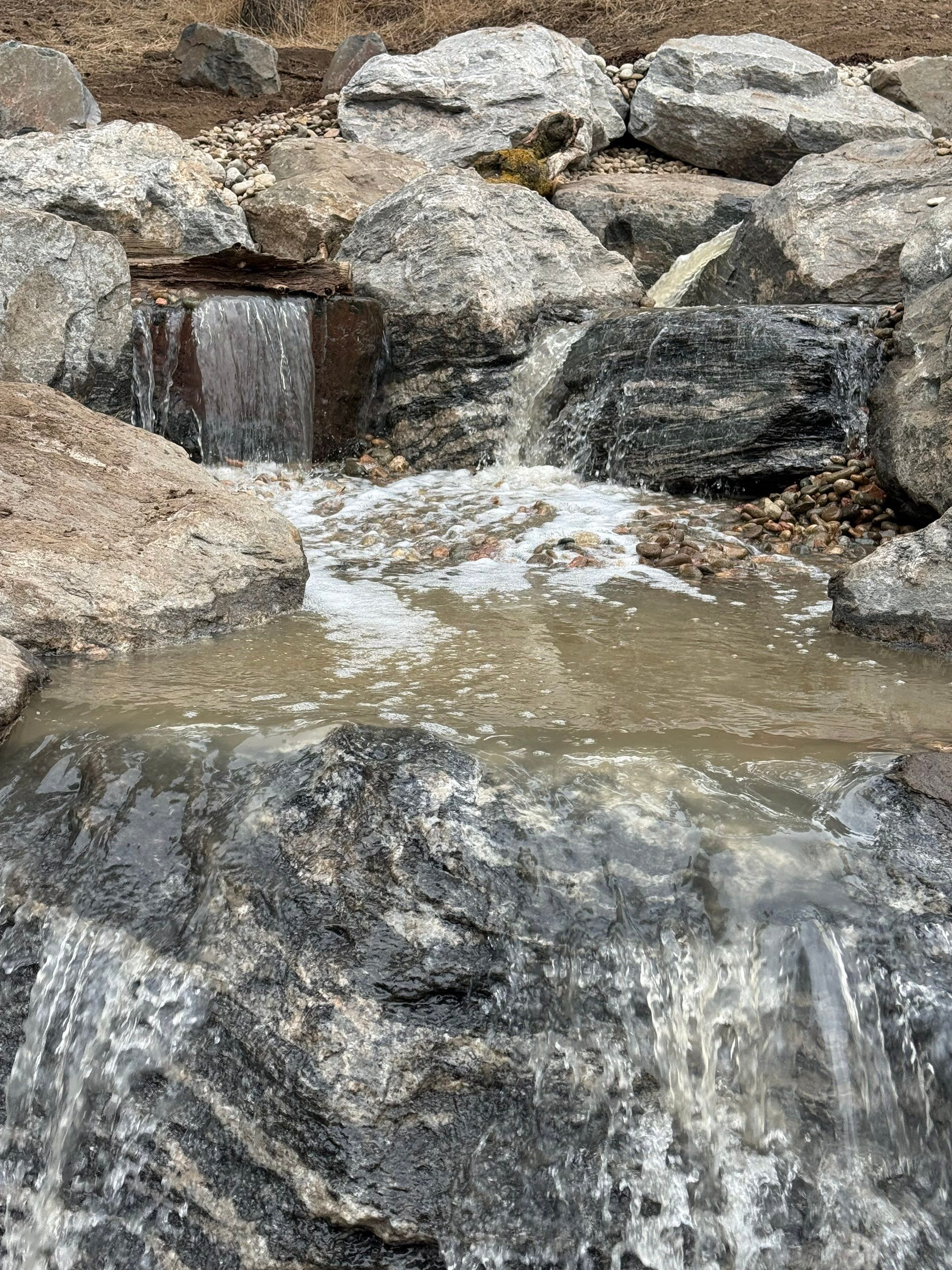 large waterfall and deck by JRM landscape & design