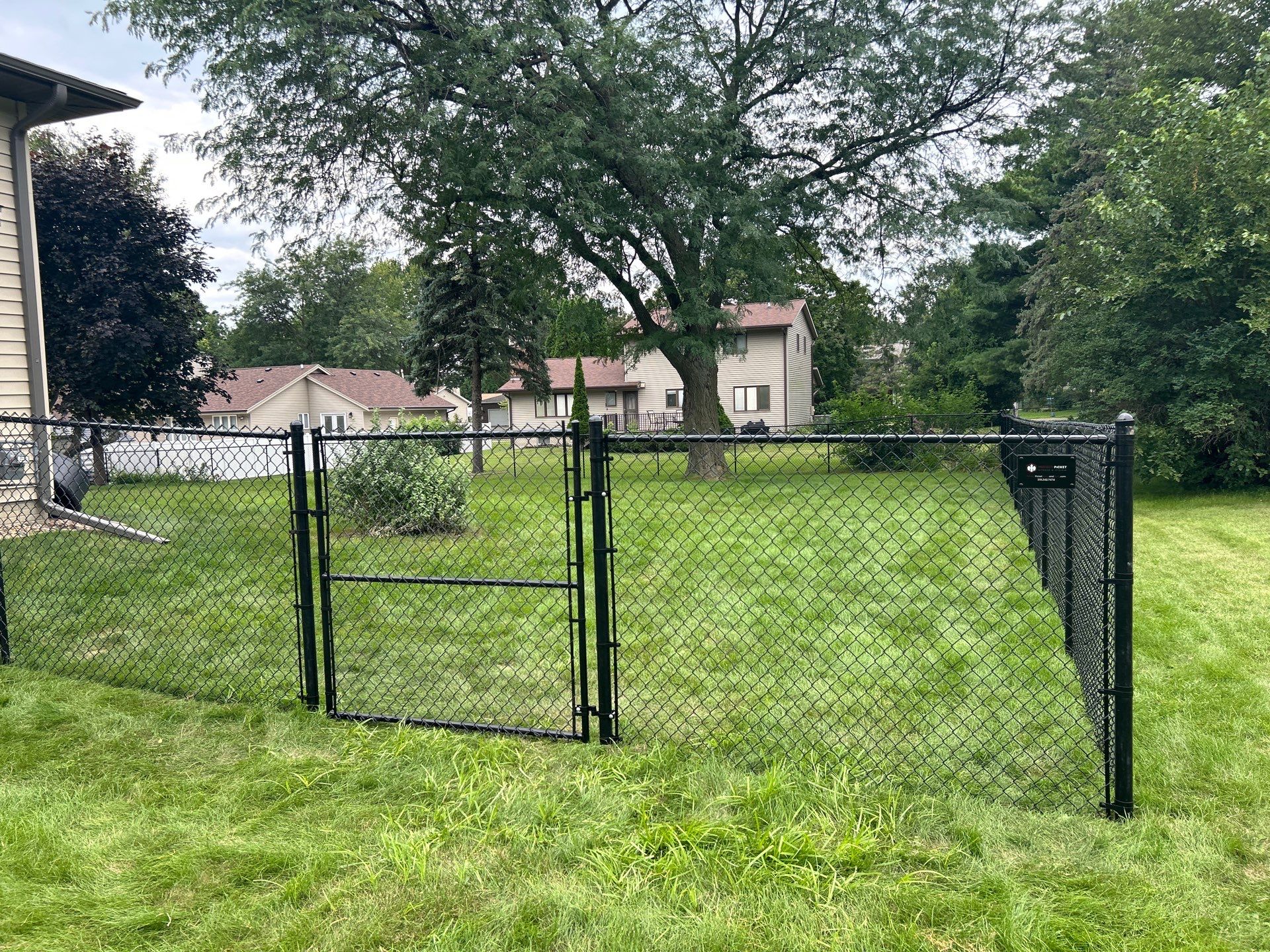 Black Vinyl-Coated Chain Link Fence Installation in Waterloo by Perfect Picket Fence and Stain