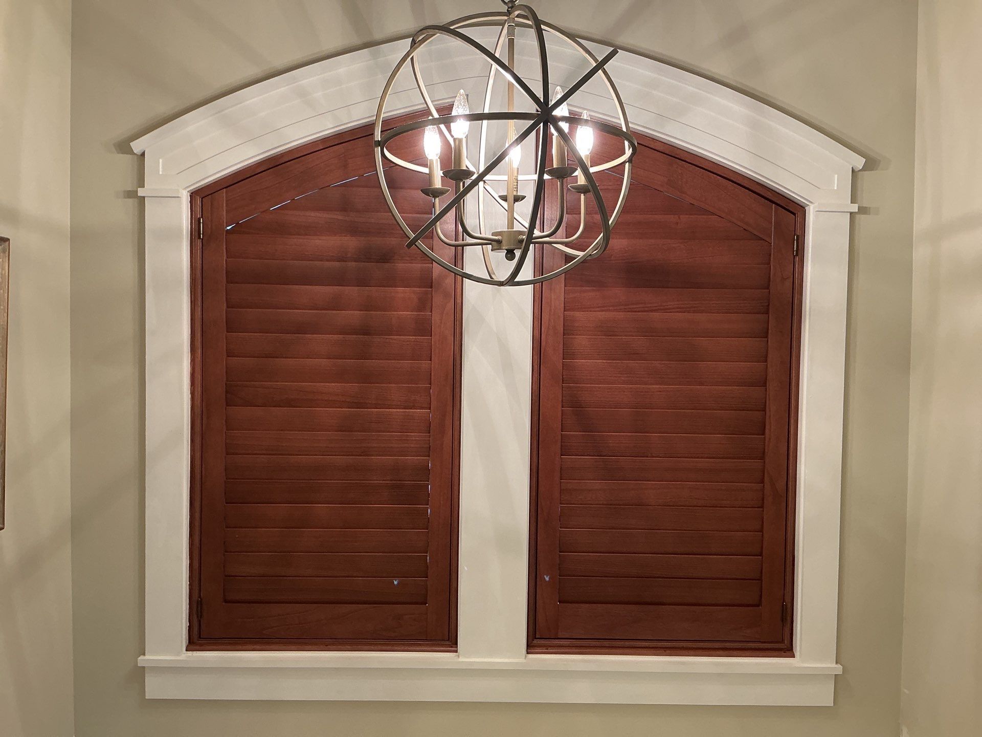 Stained Wood Plantation Shutter Upgrade for Arched Windows in St Joseph by tracy.hickman@budgetblinds.com