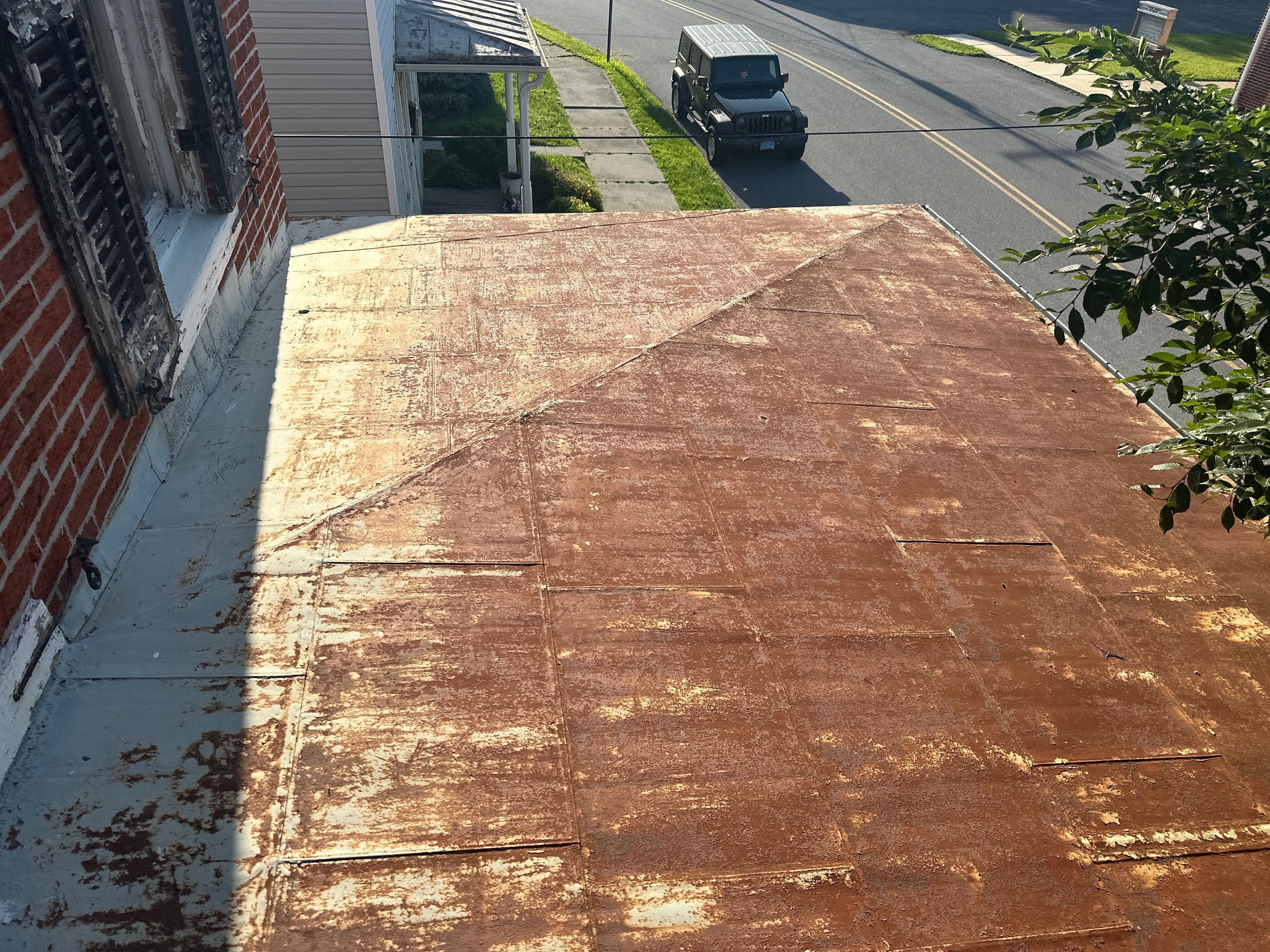 Updated Porch Roof with Clean Standing Seam Lines by Esh Builders