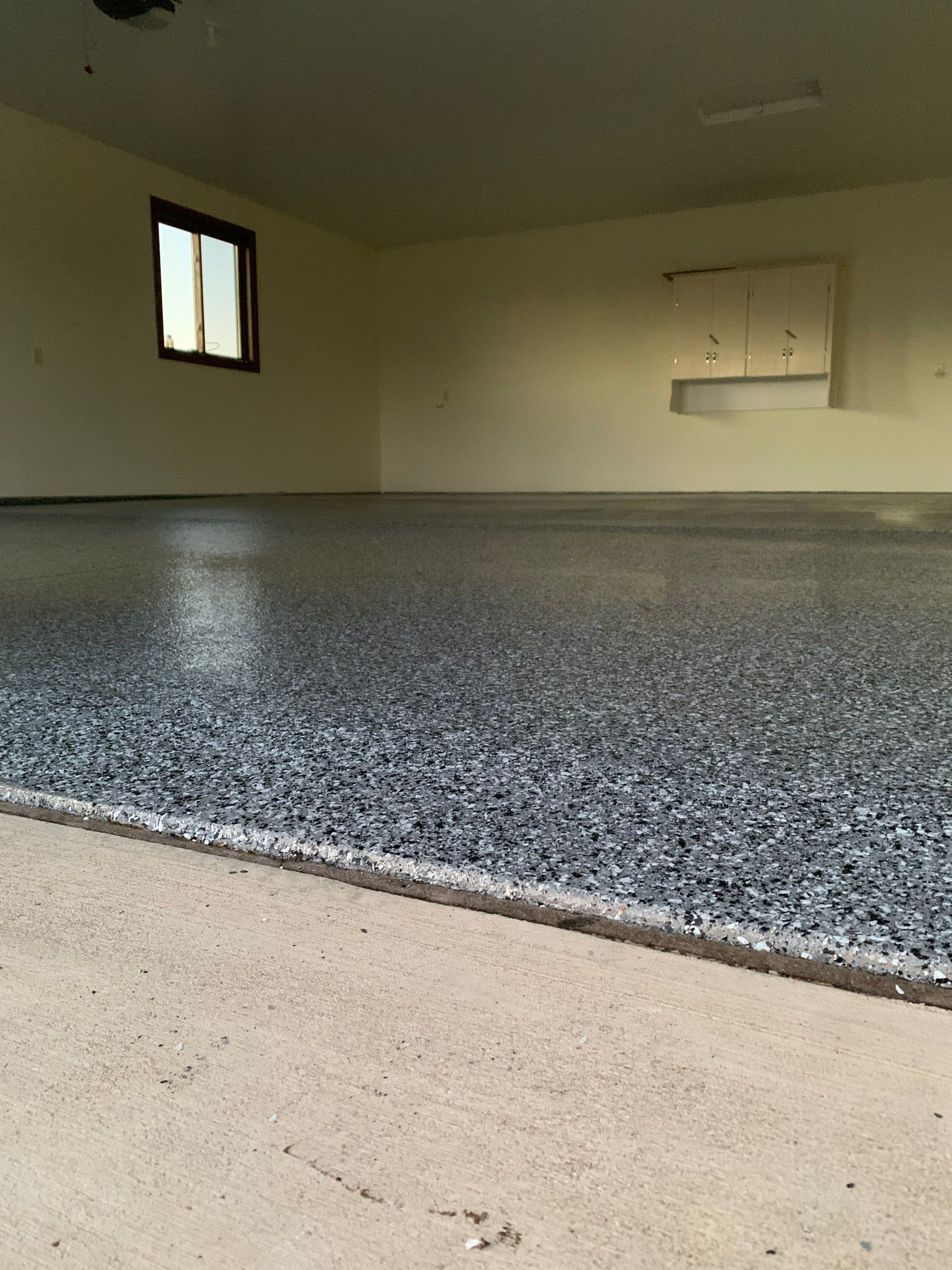 Speckled Epoxy Garage Floor Coating and Concrete Repair in Lennox by Select Painting, Coatings & Garage Cabinets