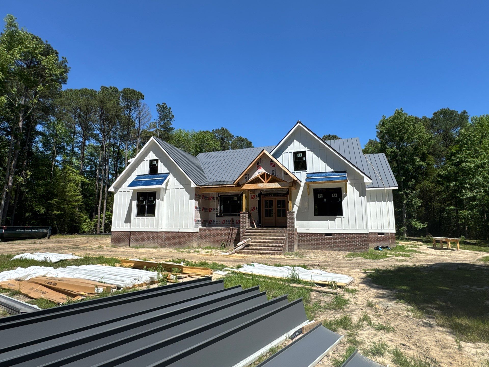 Custom New Construction Home Featuring Standing Seam Metal Roofing in Port Haywood by Cade Construction