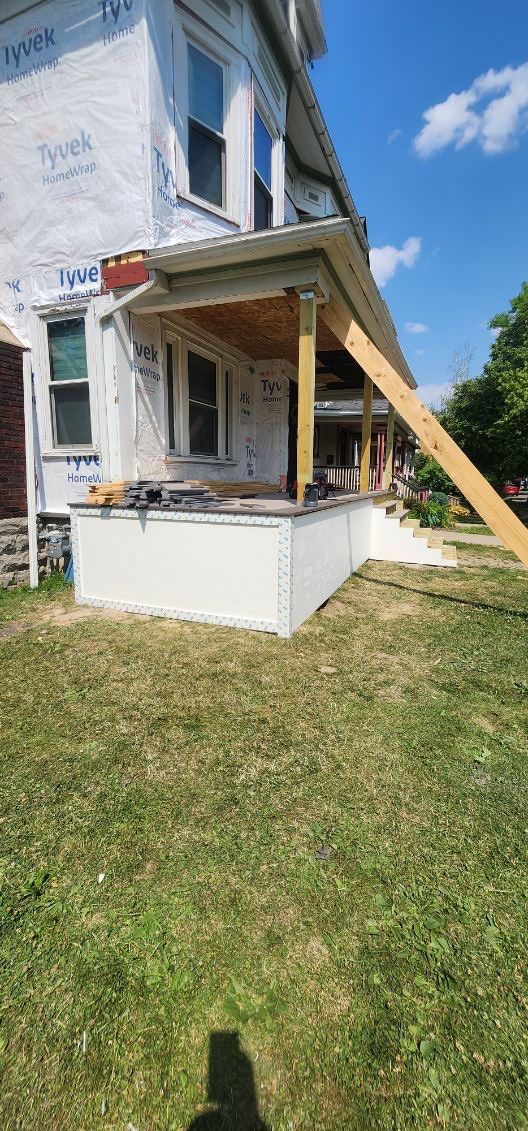 Exterior Renovations- Siding, Stamped Concrete, Porch, and Railings by Ivy Lea Construction