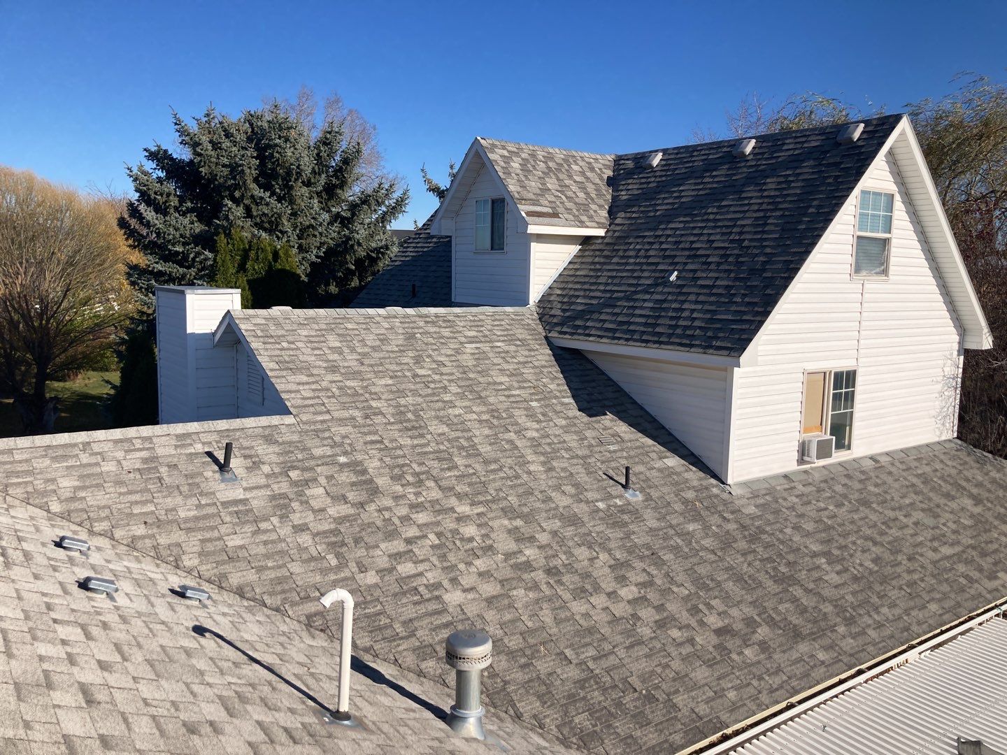 Two story farmhouse style roofing installation using Owens Corning Duration in the color Teak by ID Roofing LLC