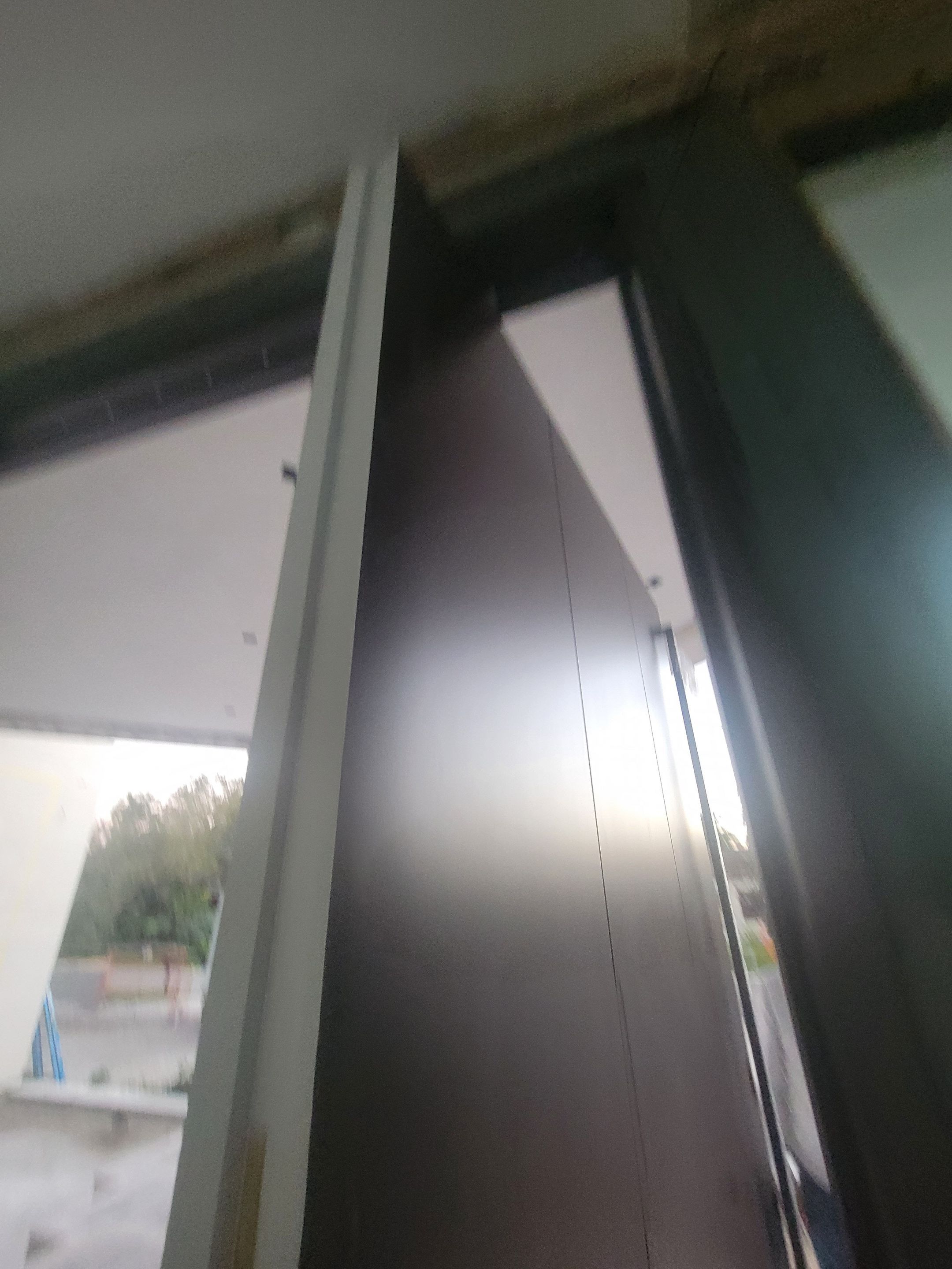 Custom Material Pivot Door installation by Impact Precious Wood Inc.
