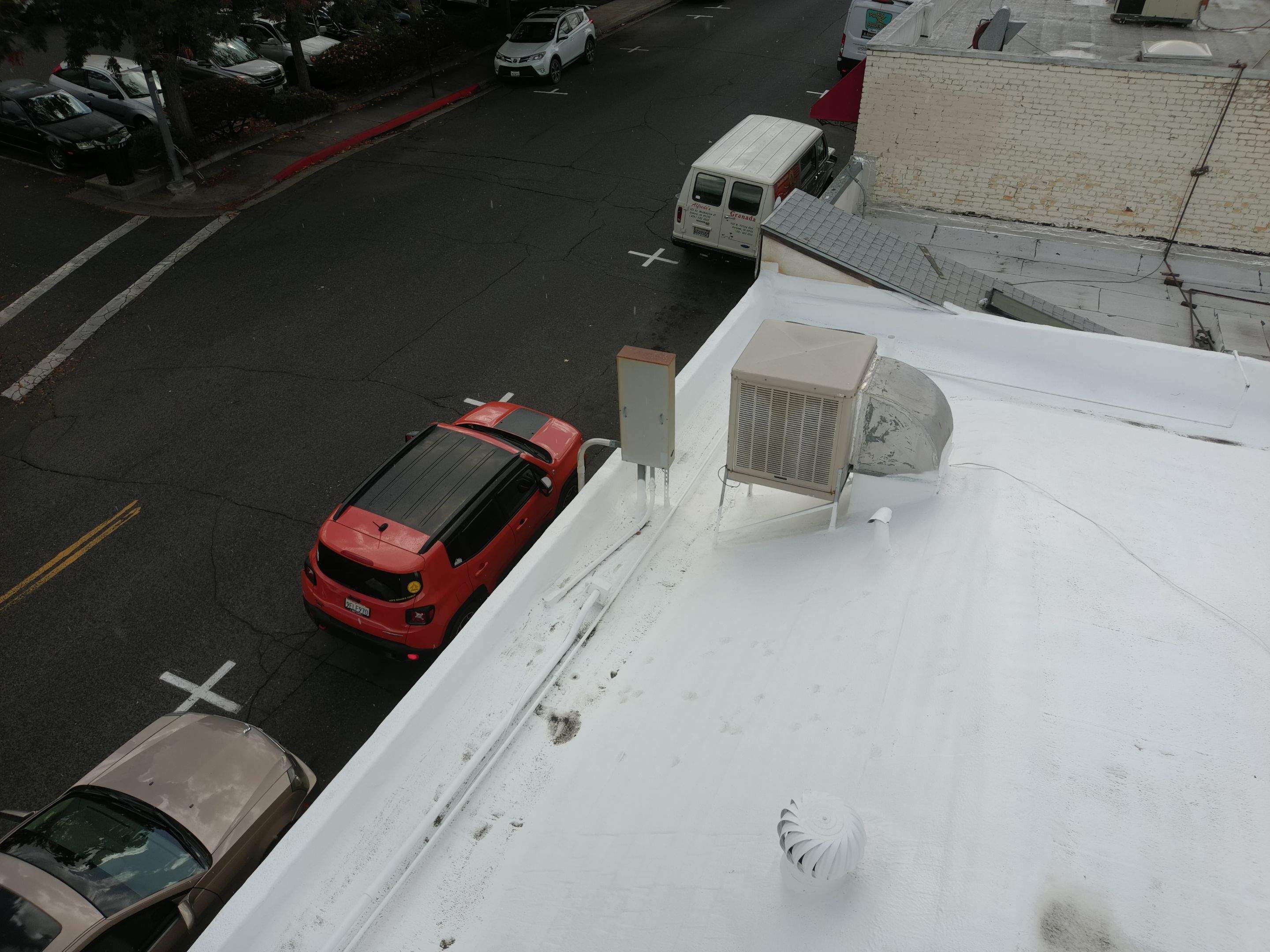 Foam and coatings on commercial roof by Straight Edge Roofing Inc