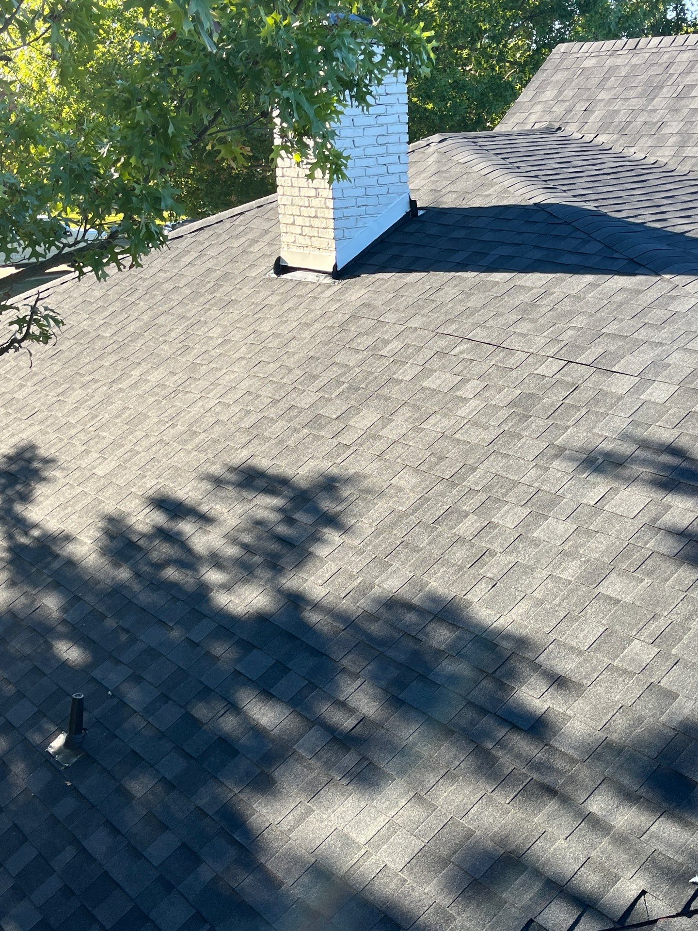 White brick with IKO Granite Black by Tejas Roofworks + Restoration