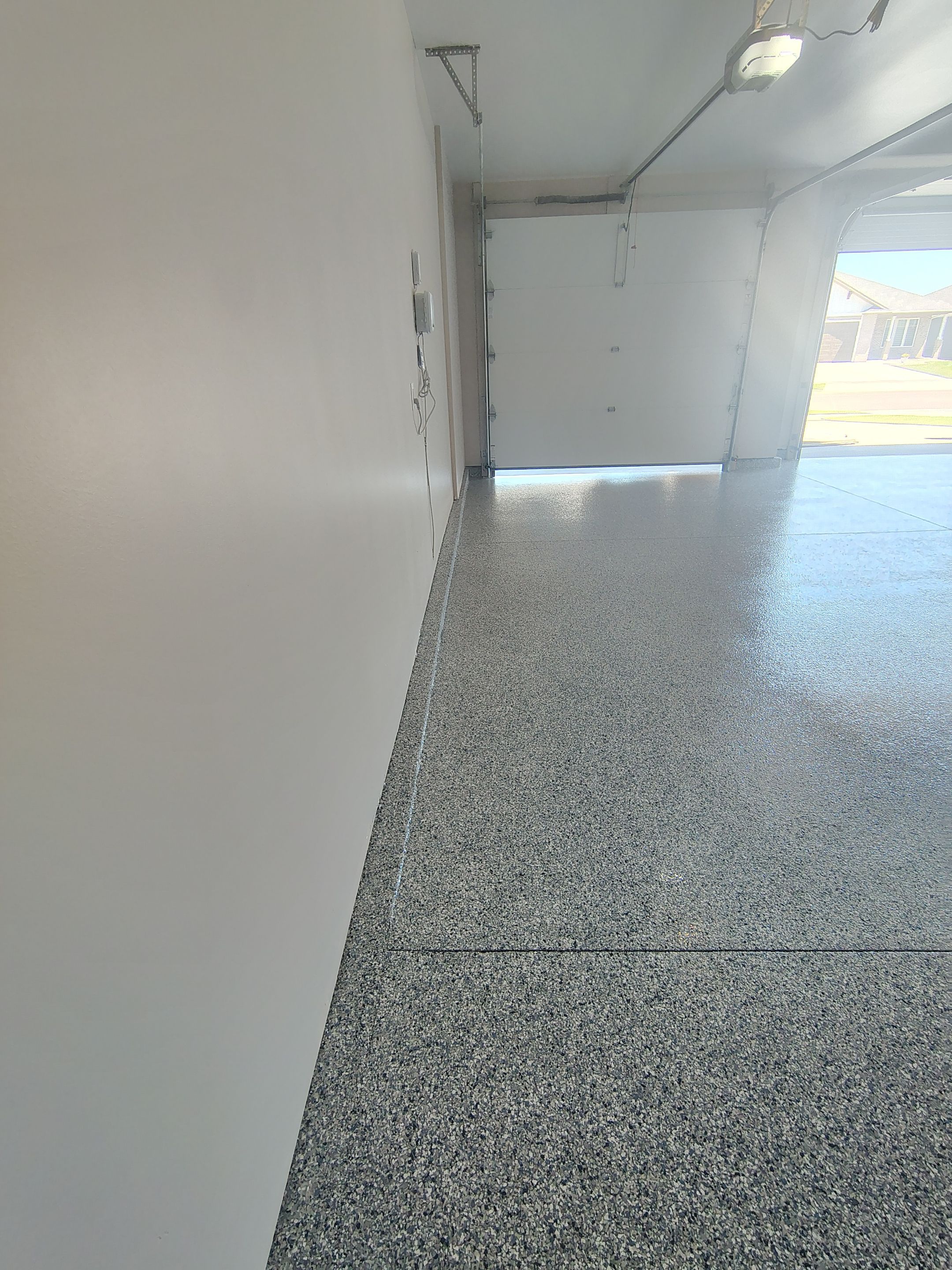 Full Speckled Concrete Coating for Sioux Falls Garage by Select Painting, Coatings & Garage Cabinets