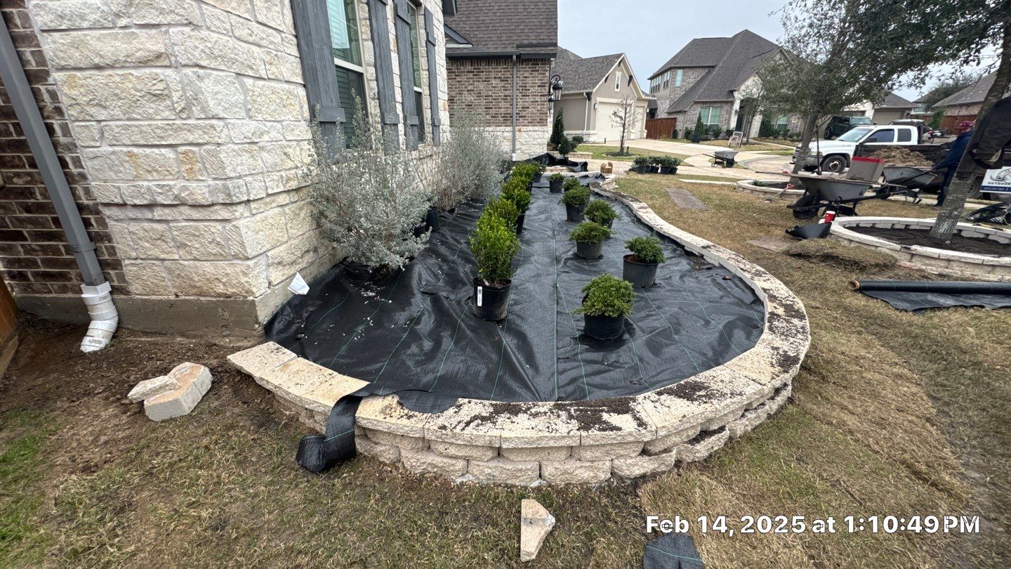 🌿✨ Darlene & Andrew’s Amazing Curb Appeal Transformation  Some projects are more than just landscaping—they’re a conversion of curb appeal from the ground up. For Darlene & Andrew, Alejandro and the Texas Urban Team designed and delivered a complete solution that reshaped their flower beds, solved drainage challenges, and gave new life to the sideyard.  💡 From planning to execution, every step was tailored to build both beauty and functionality:  🌸 Flower Beds, Reinvented  Demolition of old beds, plants, and mulch.  Fresh soil preparation, weed protection, and a brand-new retainer wall built with hand-cut stone and decorative caps.  Carefully selected plants and garden mix to ensure health and visual harmony.  💧 Drainage & Irrigation Upgrades  Outdated corrugated pipes replaced with PVC drainage lines to carry water safely away from the foundation.  New irrigation system combining drip lines and sprinklers—watering plants while keeping the house walls protected.  Sideyard drainage extended with catch basins and PVC piping to prevent water pooling and foundation stress.  🚶 Functional Sideyard with Walkway & Trash Area  Graded and leveled sideyard to manage runoff.  Installed a modern gravel and paver walkway for easy access.  Built a firm and tidy concrete-paver pad for trash containers—making the space both practical and polished.  🛠️ Stonework & Craftsmanship  Every stone in the retainer wall was cut, set, and secured by the team of handcrafters, ensuring a durable build that doubles as a design statement.  ✅ Outcome: Darlene & Andrew’s property now has better drainage, a clean and organized sideyard, and elegant new flower beds—all designed for long-term durability and lasting beauty.  📢 Before hiring anyone, review our portfolio. Our work speaks louder than words—each project is a blend of function, protection, and design crafted to last. by Texas Urban Elements