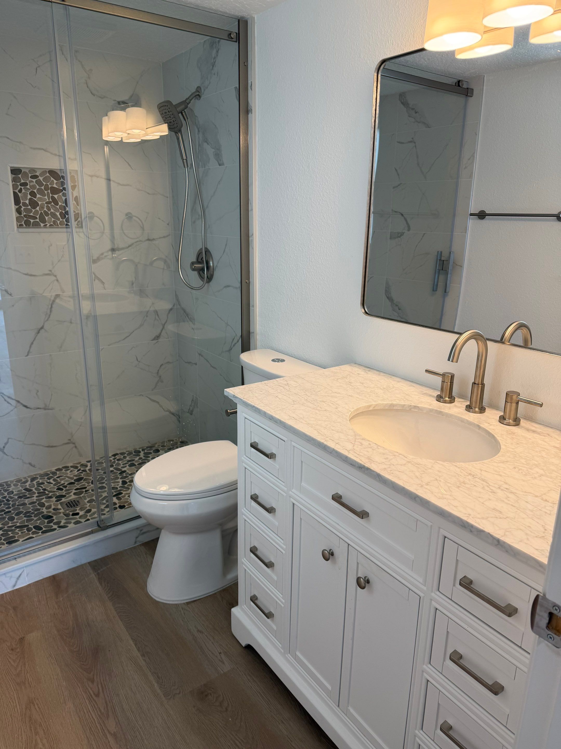 Full Condominium Remodel Featuring Aubrey Oak Flooring In Daytona Beach by Acies Renovations