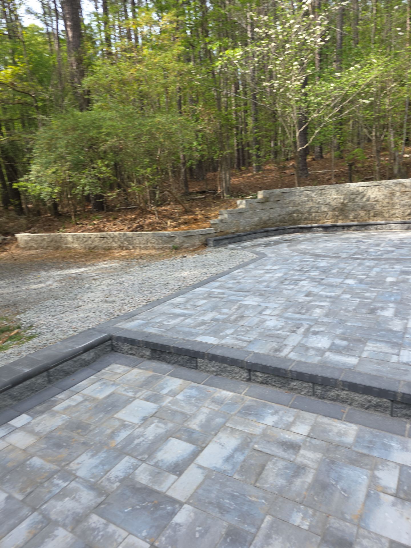 Pittsboro Outdoor Living Transformation – Retaining Wall, Paver Patio & Elevated Deck by Elite Remodeling and Design LLC