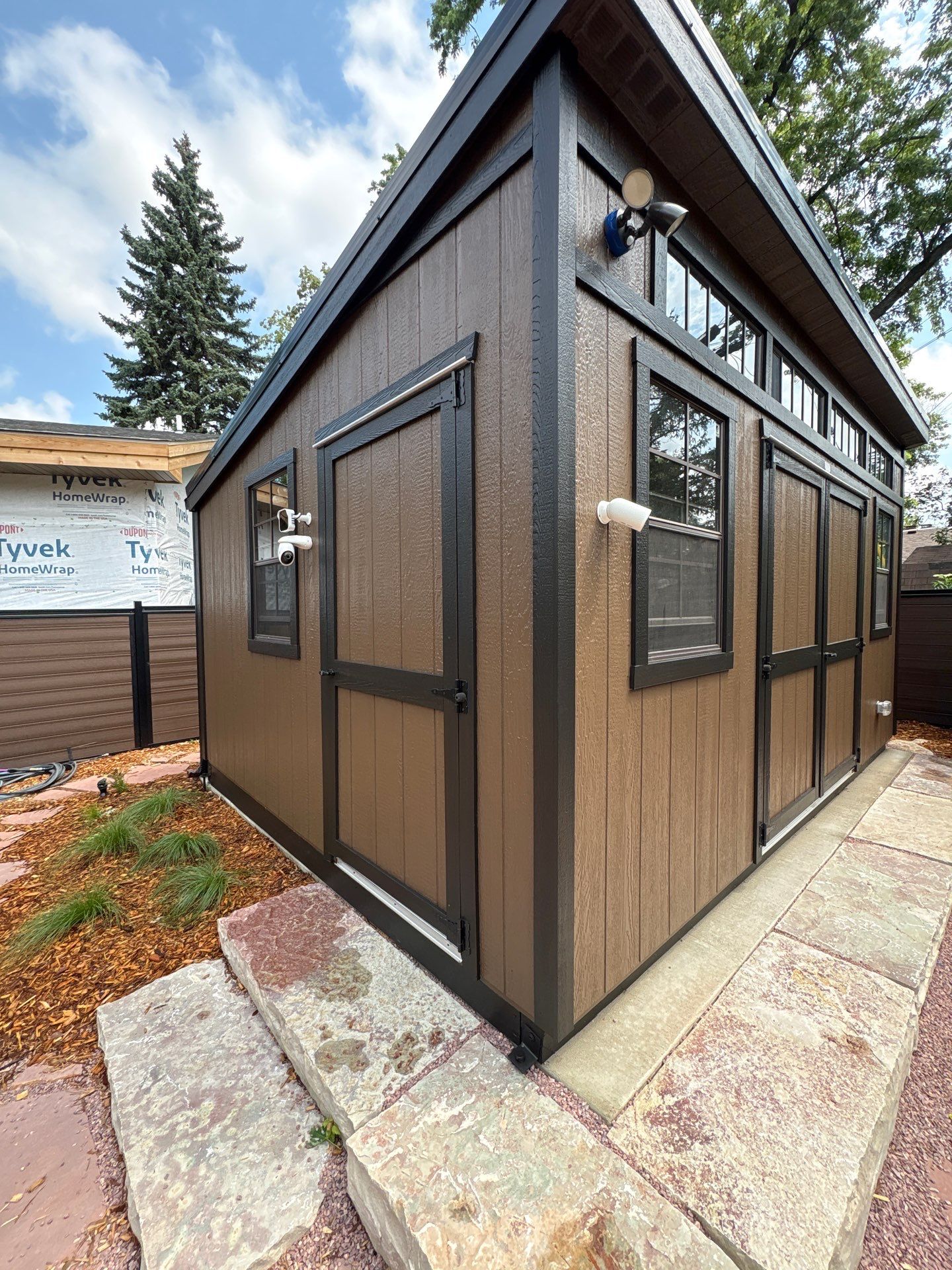 Modern Shed Construction with Stone Foundation in Sioux Falls by Select Painting, Coatings & Garage Cabinets
