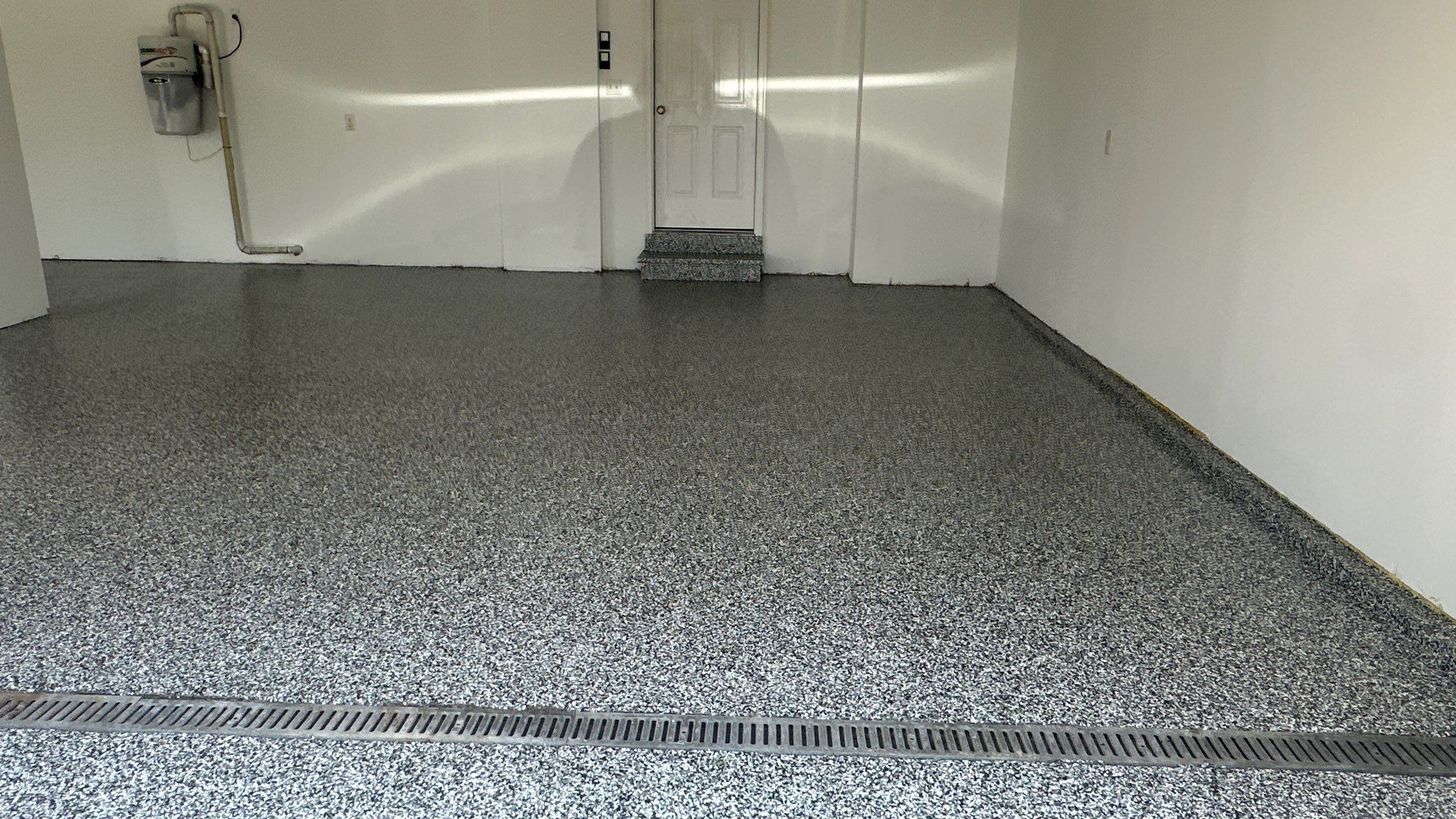 Laura B. garage transformation with a new floor and garage storage  by Banner Garage