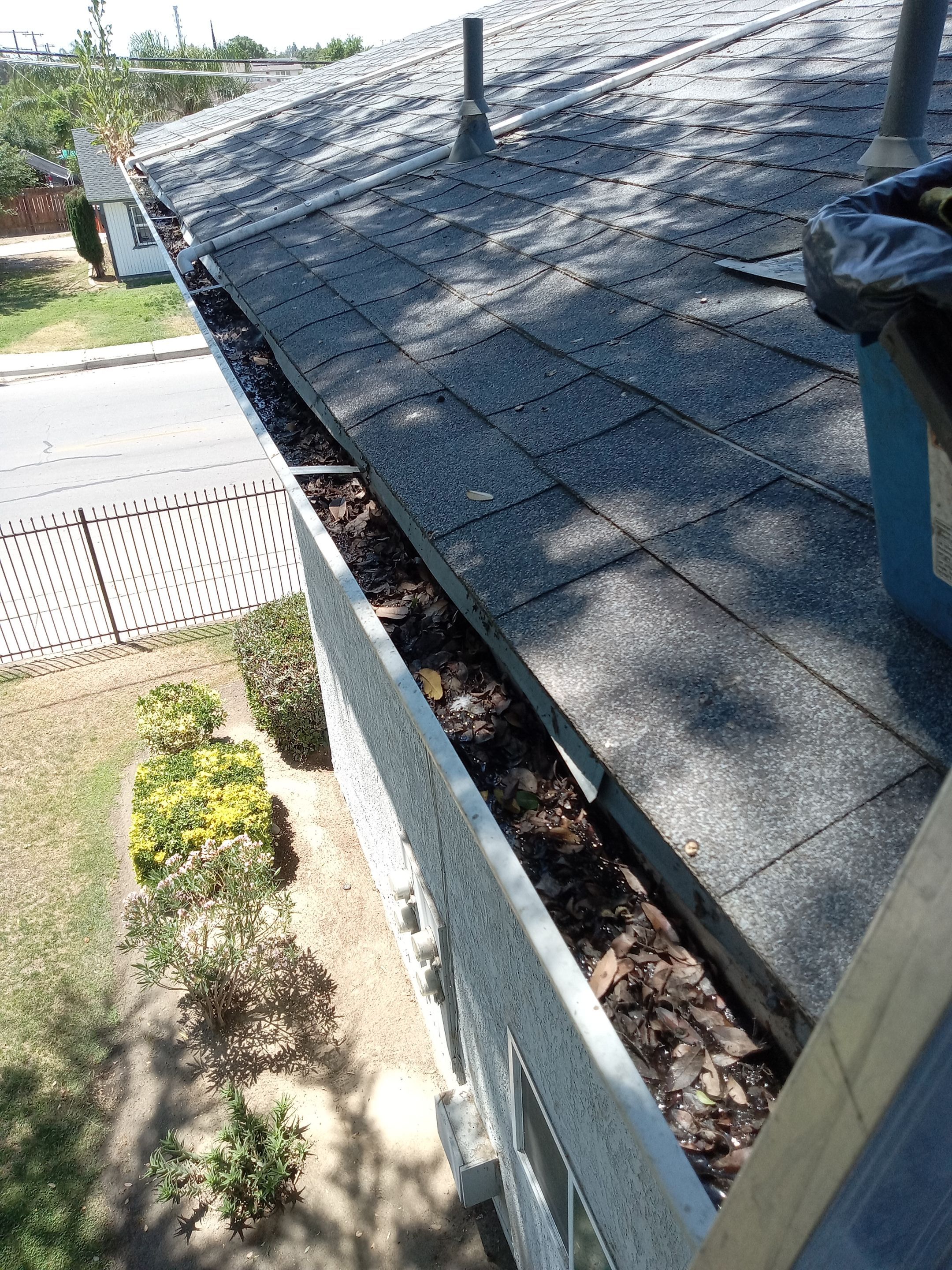Commercial gutter cleaning Pixley, CA before photo with filled gutters