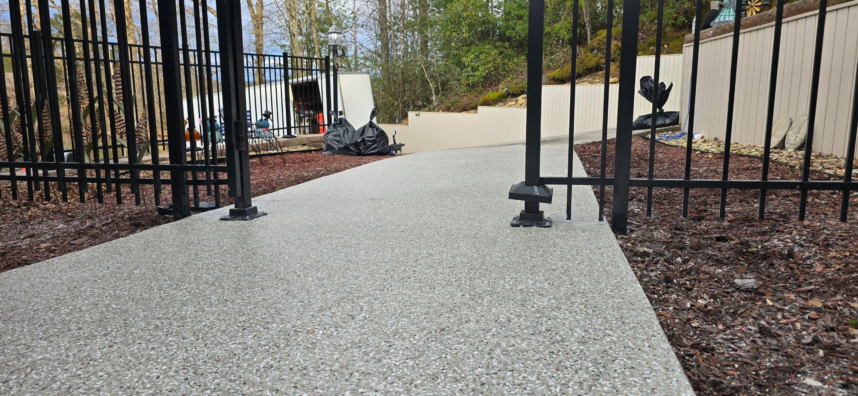 Garage & Sidewalk using Creekbed by Elite Floor Solutions