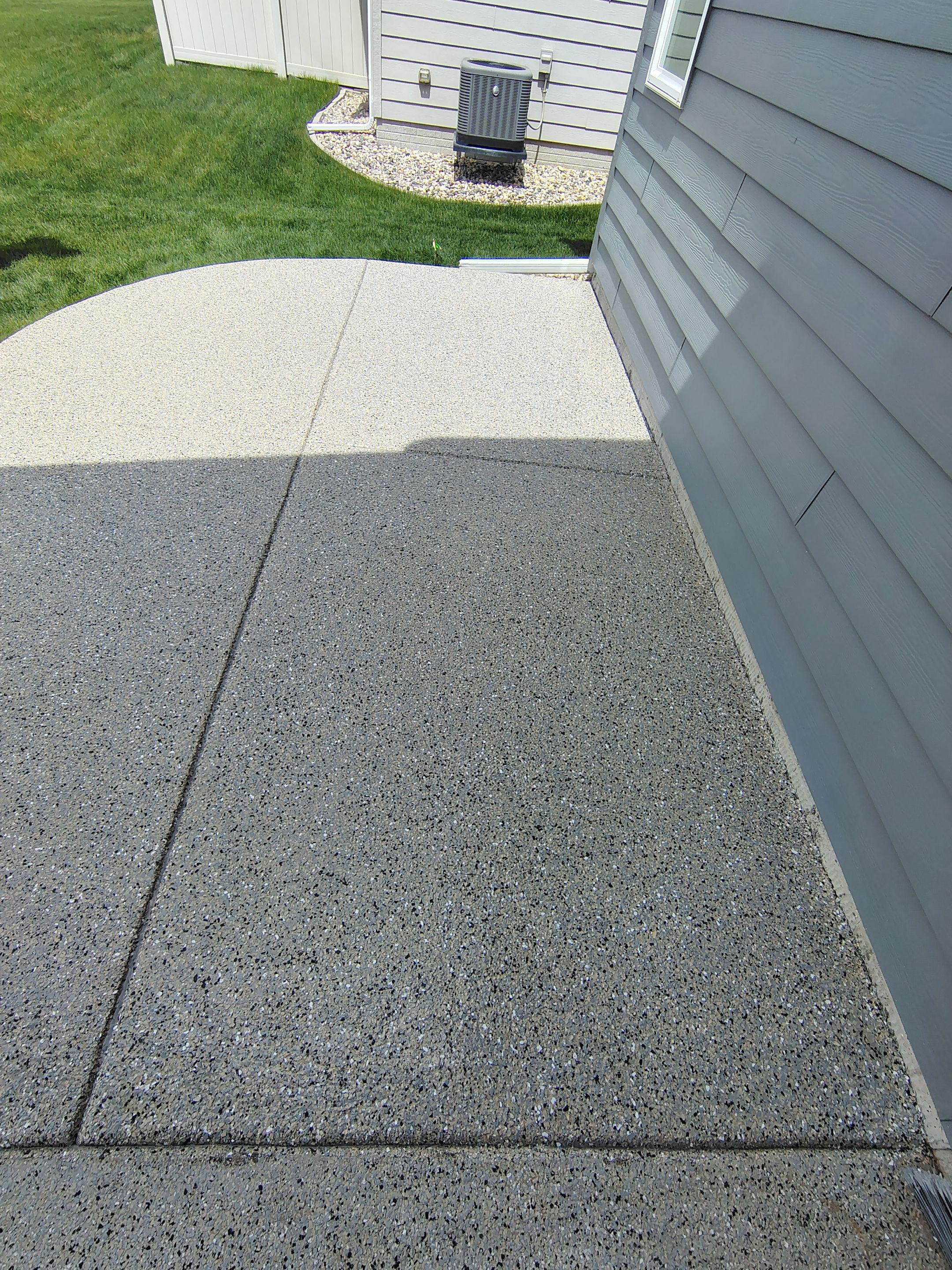 Speckled Concrete Patio Coating Installation in Sioux Falls by Select Painting, Coatings & Garage Cabinets