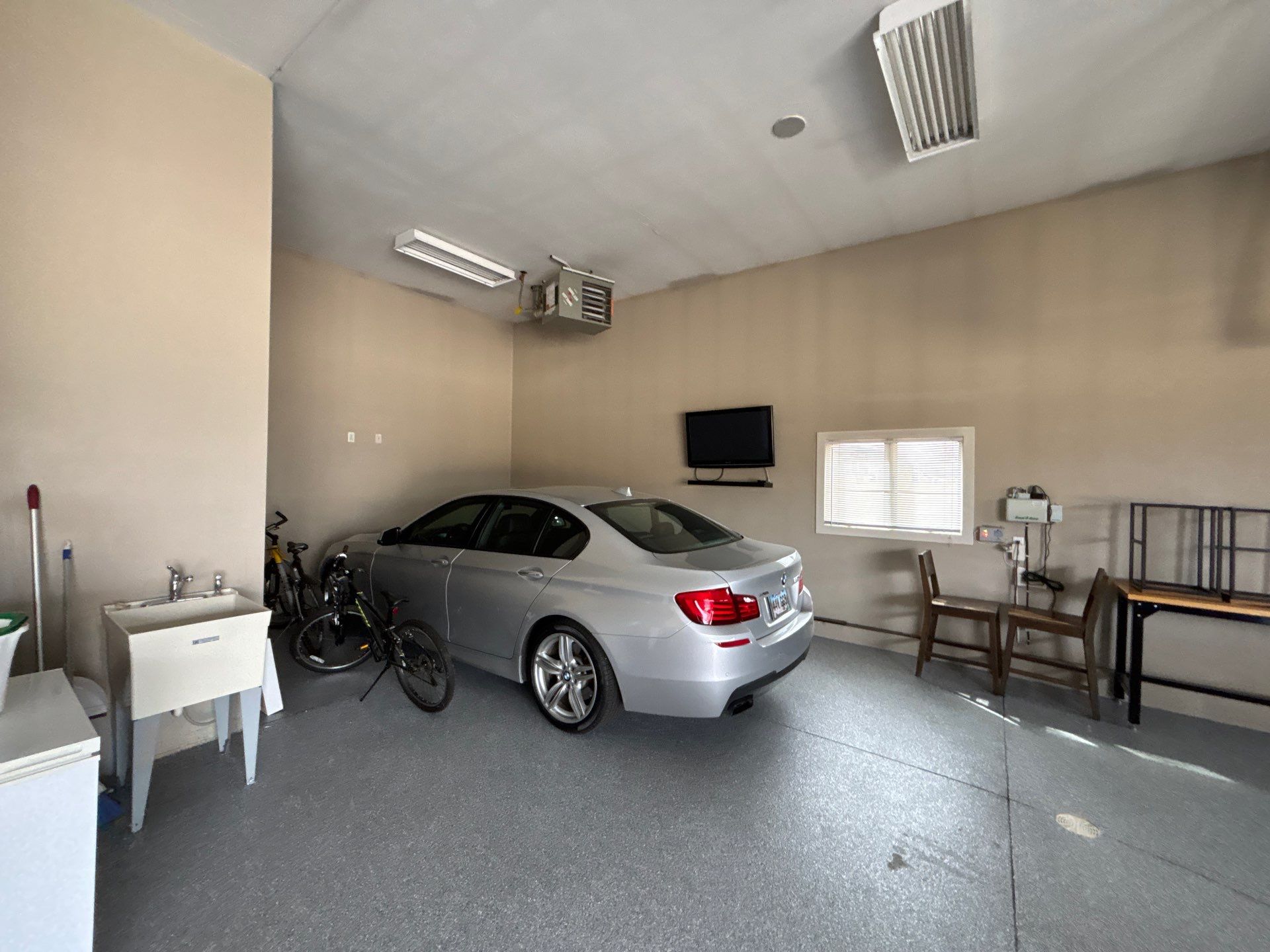 Speckled Grey Epoxy Garage Floor Coating Installation in Tea by Select Painting, Coatings & Garage Cabinets