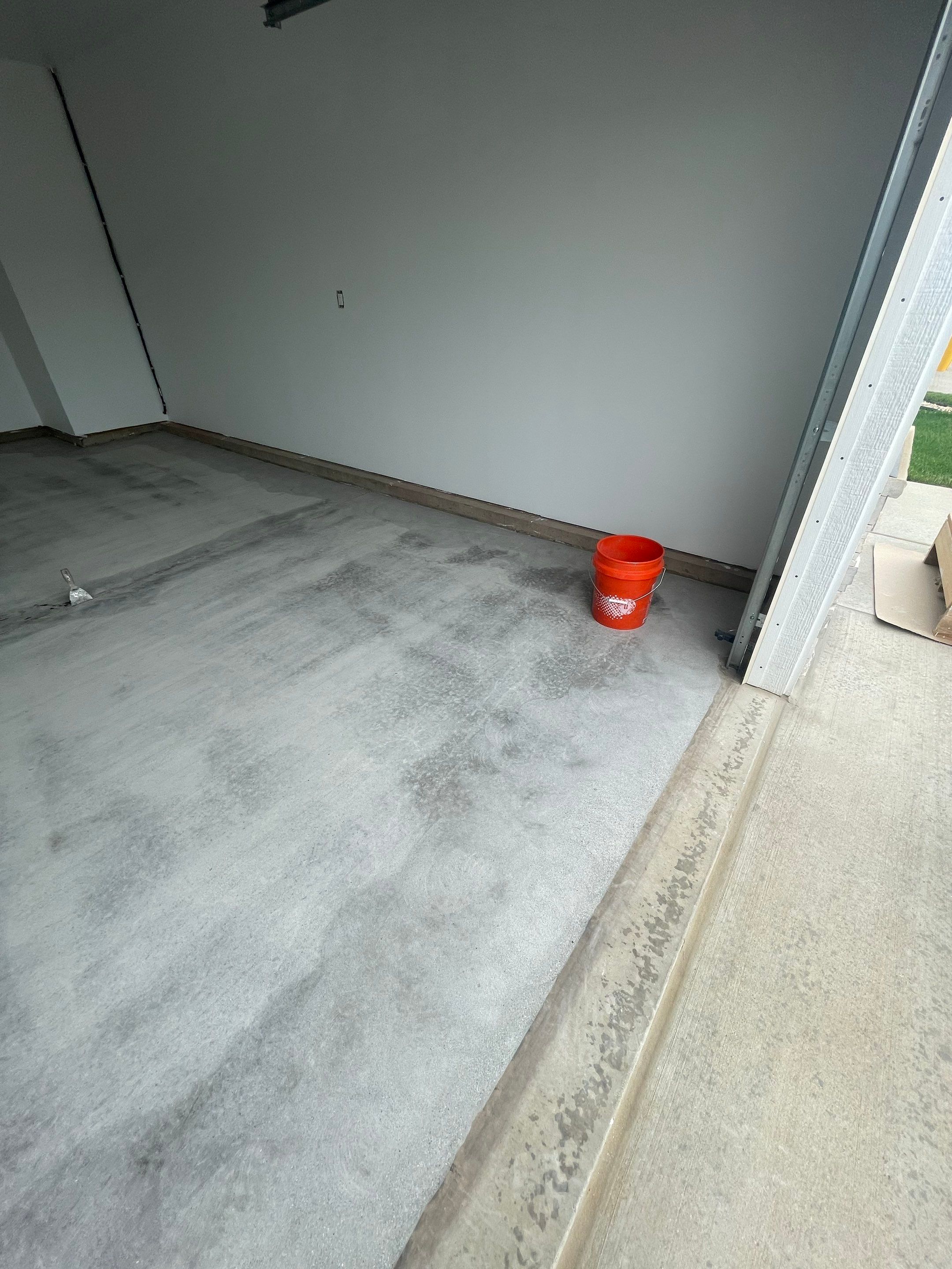 Grey Flake Epoxy Garage Floor Coating in Sioux Falls by Select Painting, Coatings & Garage Cabinets