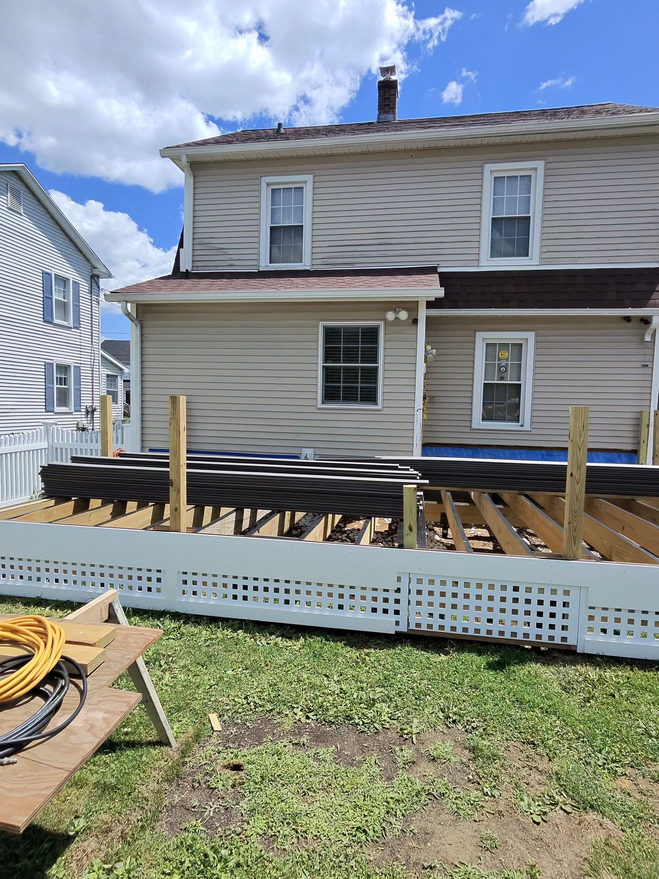 Deck Replacement usin gTrex Tropical Islandmist and Transcend Cocktail rail, Includes lattice and a gate. by DiGiorgi Roofing and Siding Inc