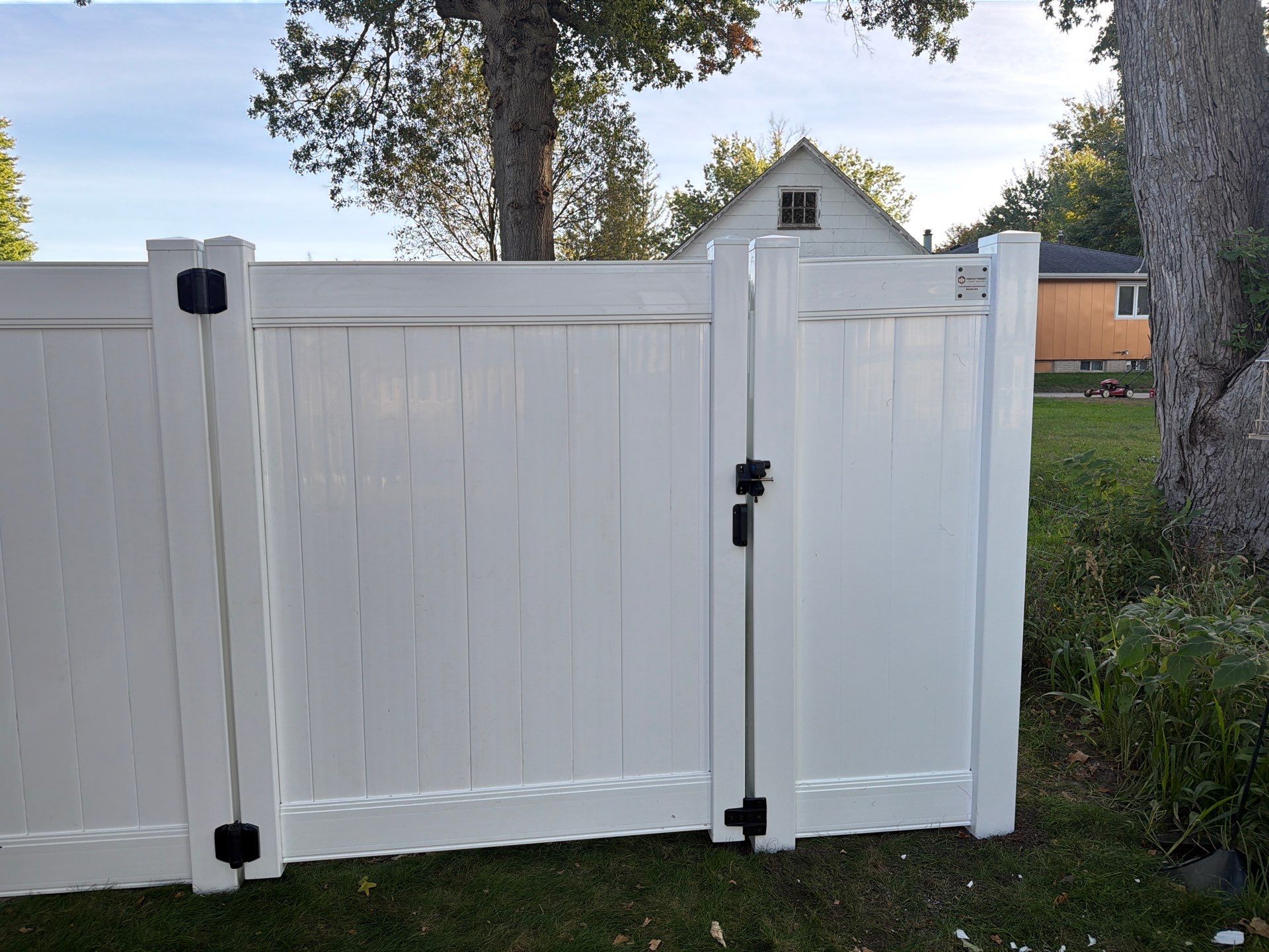 White Vinyl Privacy Fence and Gate Installation in Grundy Center by Perfect Picket Fence and Stain