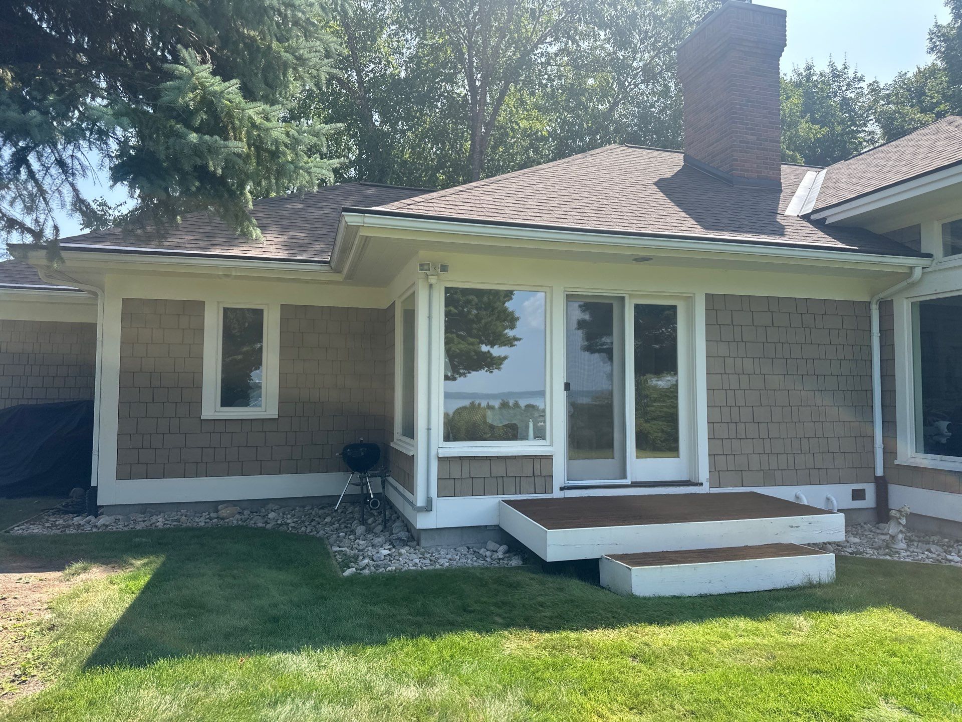 Gutter Helmet Installation for a Traverse City Residence With Shake Siding by Rainbow Seamless Systems