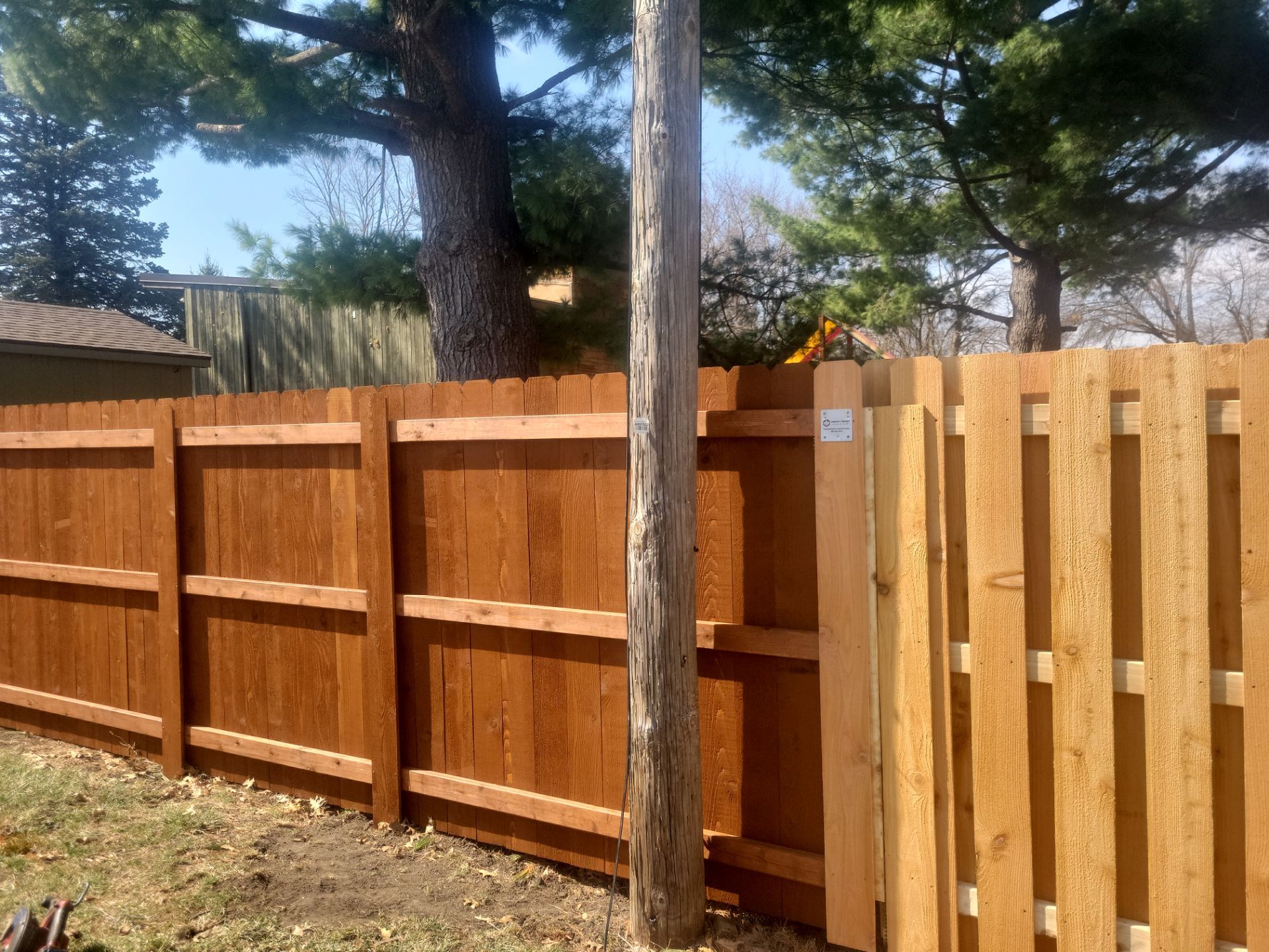 Stained Cedar Wood Privacy Fence Installation in Cedar Falls by Perfect Picket Fence and Stain