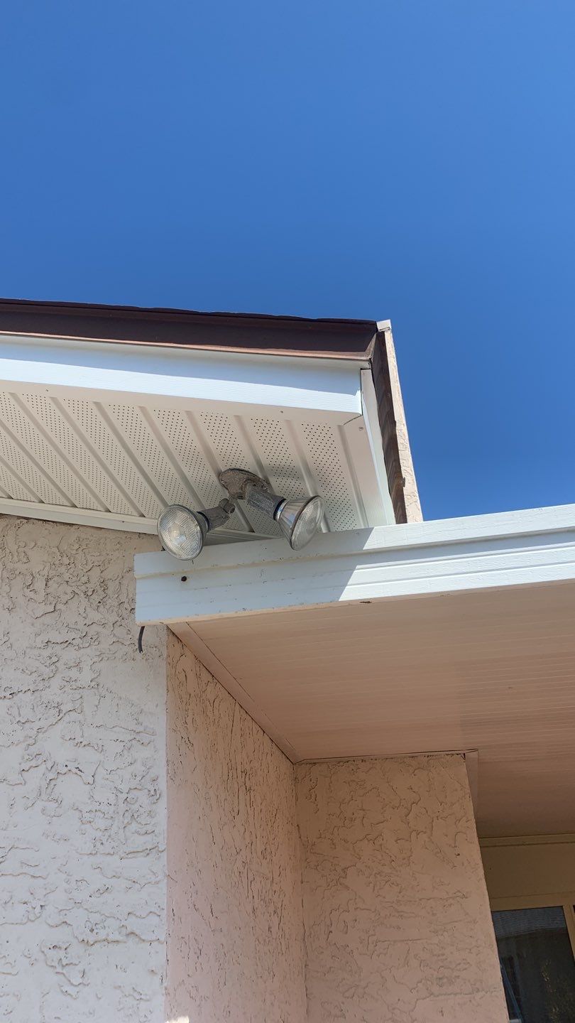 Soffit and Fascia Installation Using White Vinyl Soffit and Musket Brown Fascia by Gutter Professors
