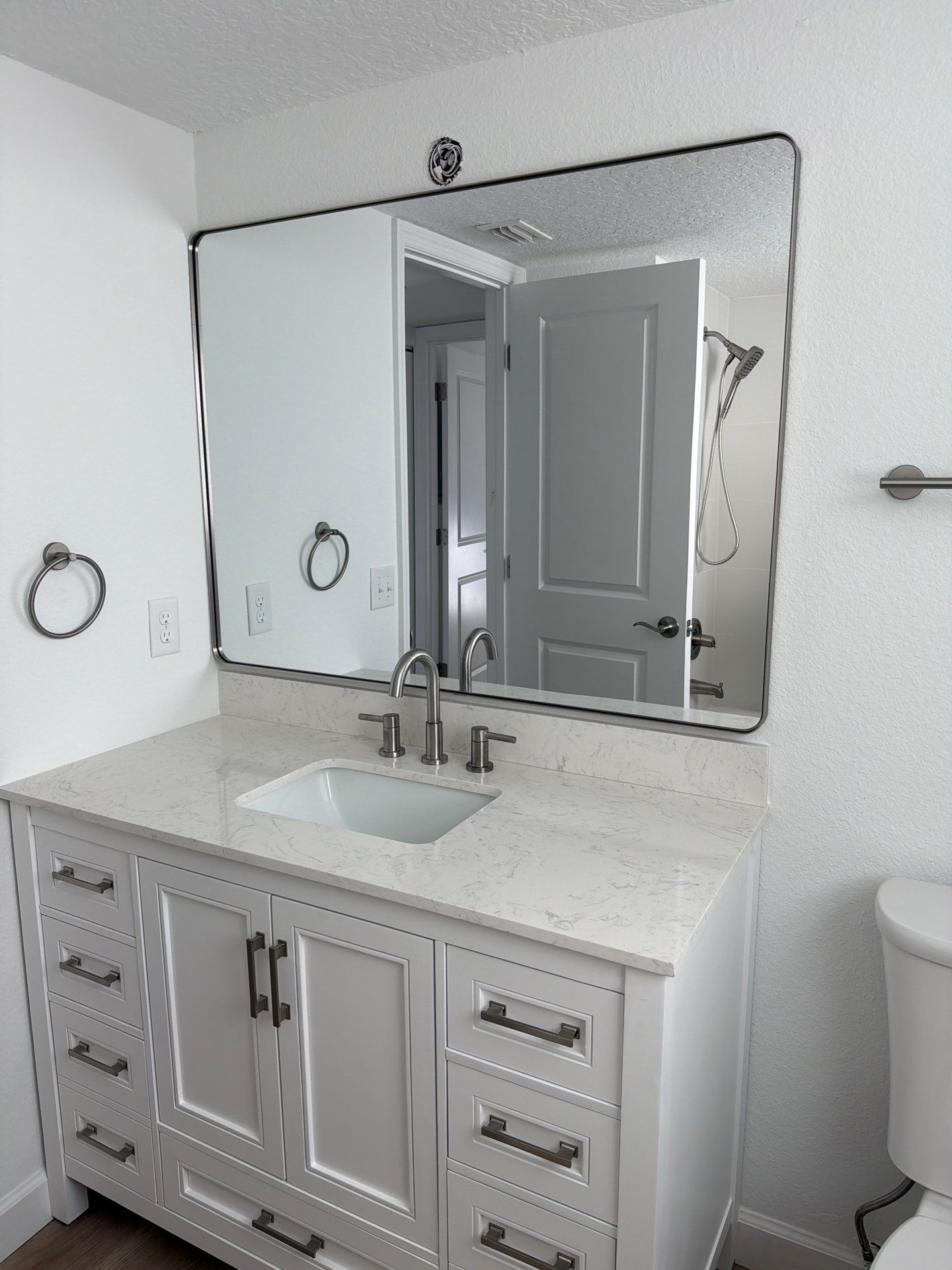 Full Condominium Remodel Featuring Aubrey Oak Flooring In Daytona Beach by Acies Renovations