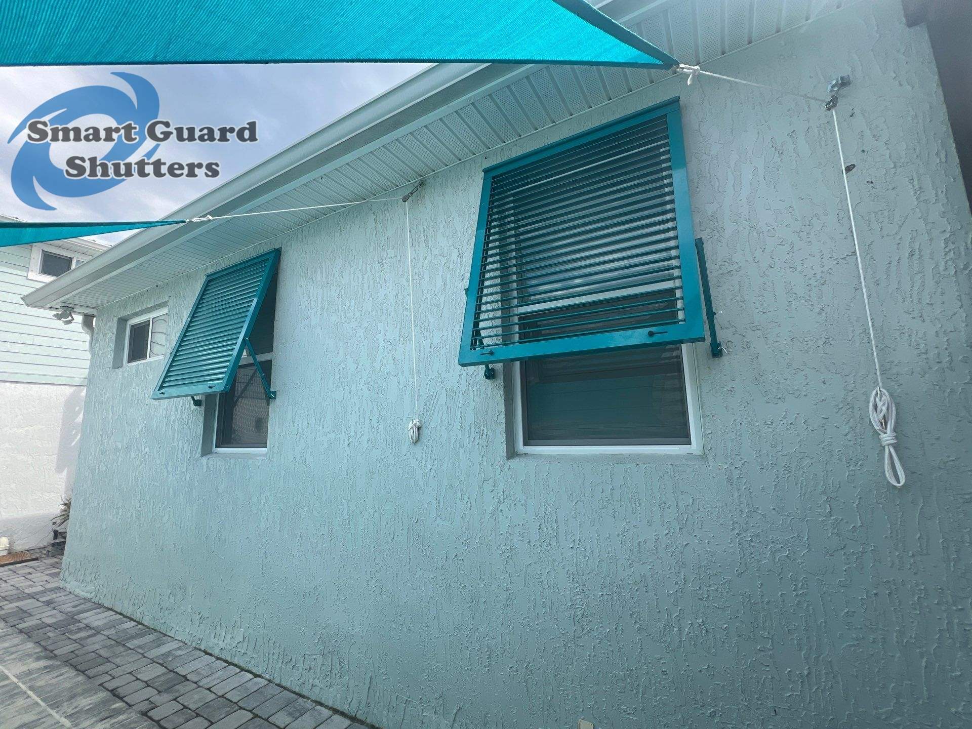 Impact Bahama Shutters in Water Blue by Smart Guard Shutters
