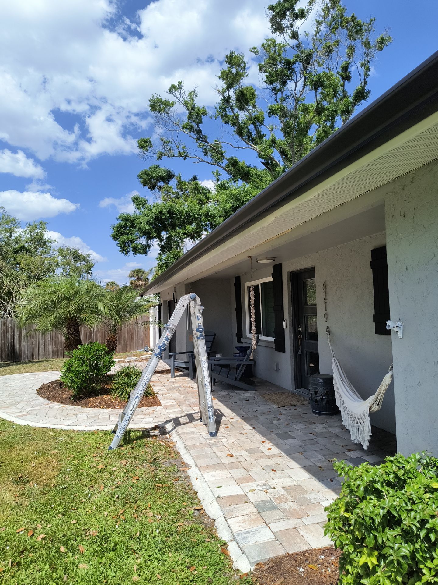 Black Seamless Gutters using 7 inch seamless gutters & New White Soffit in Sarasota FL by Gutter Professors