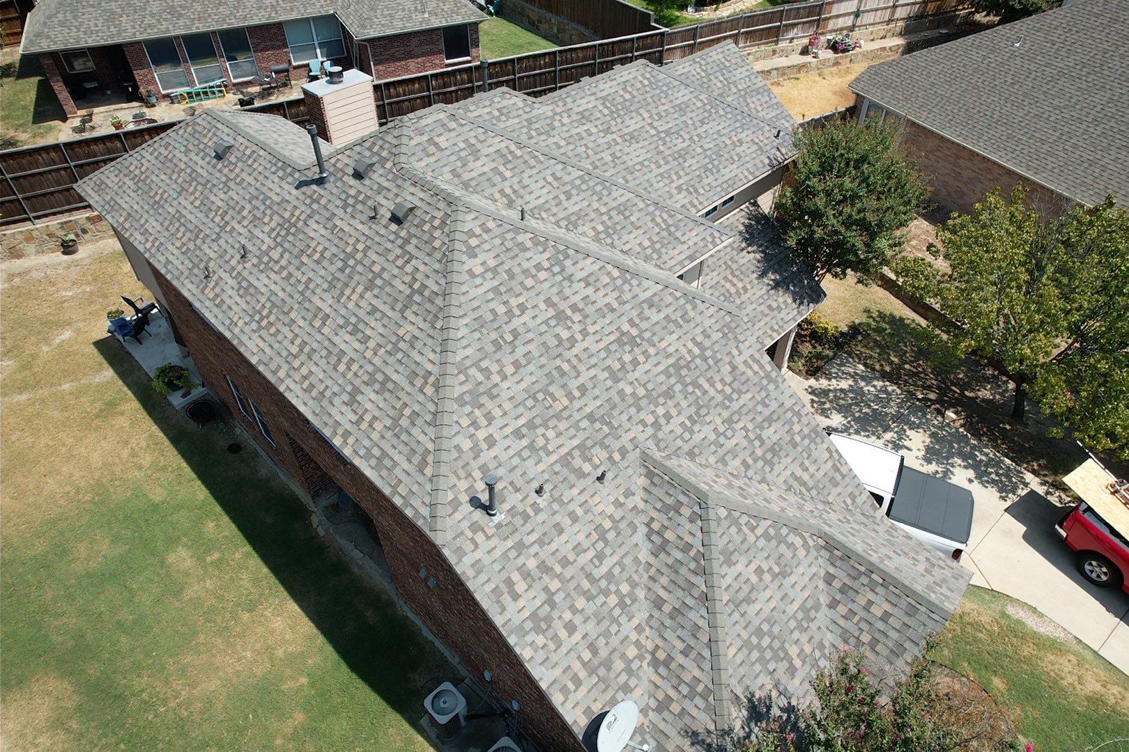 Red brick/white stone with IKO Cornerstone by Tejas Roofworks + Restoration