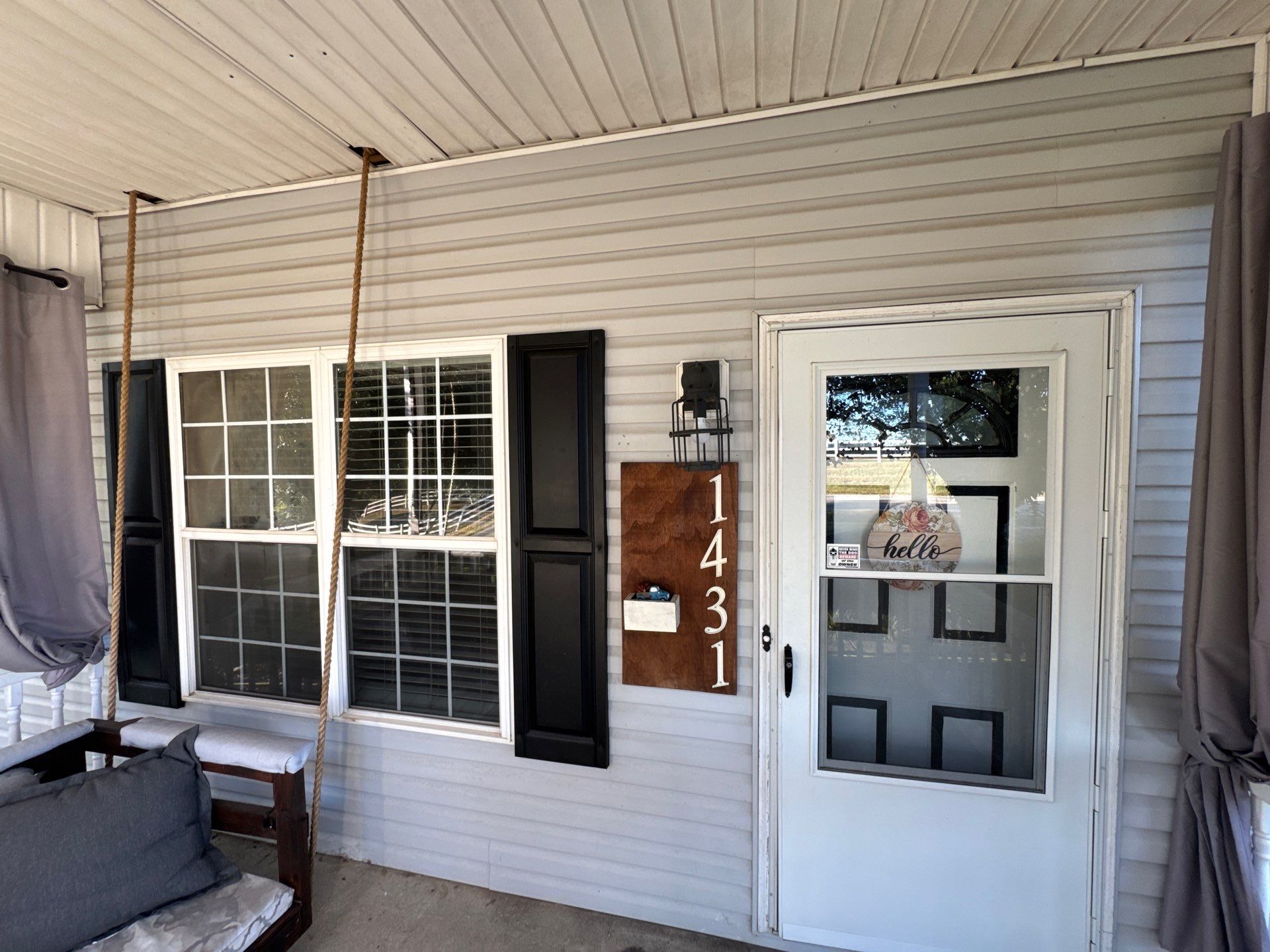 cleaning the siding windows and porch area of a house using pressure washing techniques to remove dirt and grime