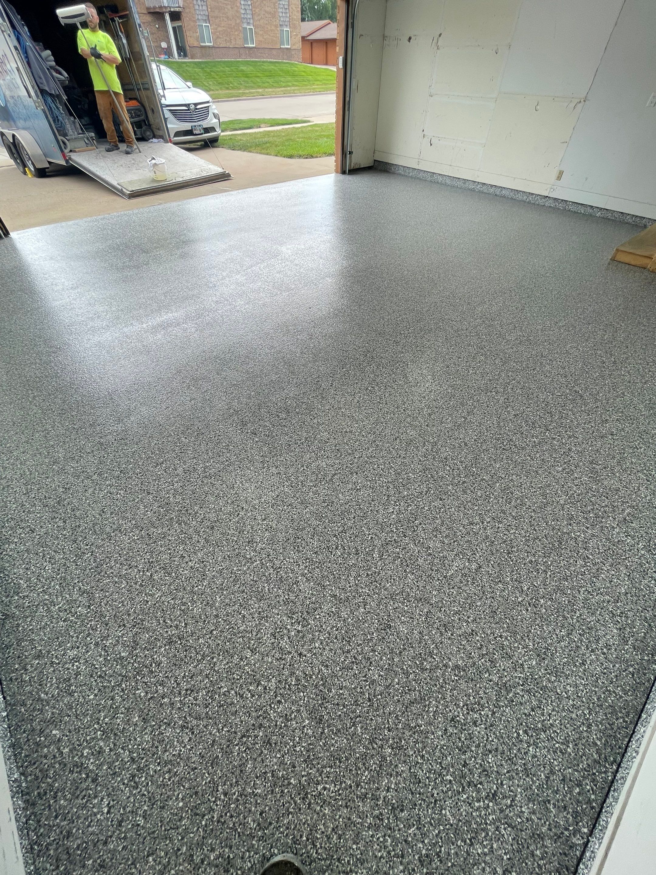 Grey Speckled Concrete Coating for Residential Garage in Yankton by Select Painting, Coatings & Garage Cabinets